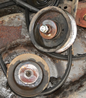 Pulleys and a belt in an engine compartment.
