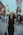 Woman strolls down a street, looking stylish.