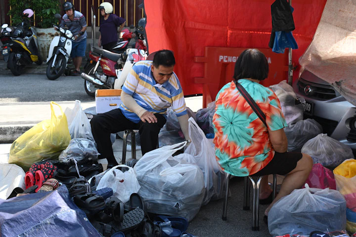 People are sorting through piles of donated clothes