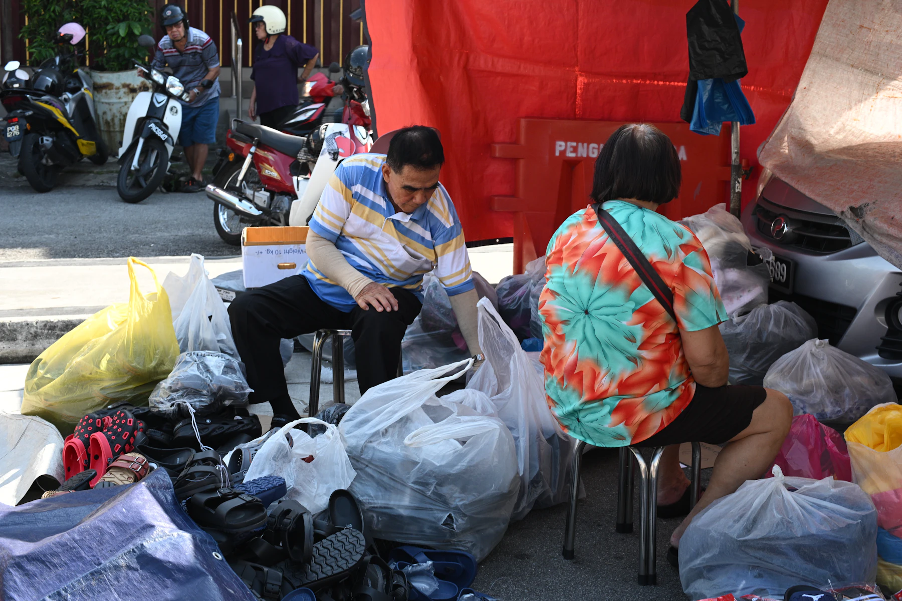 People are sorting through piles of donated clothes
