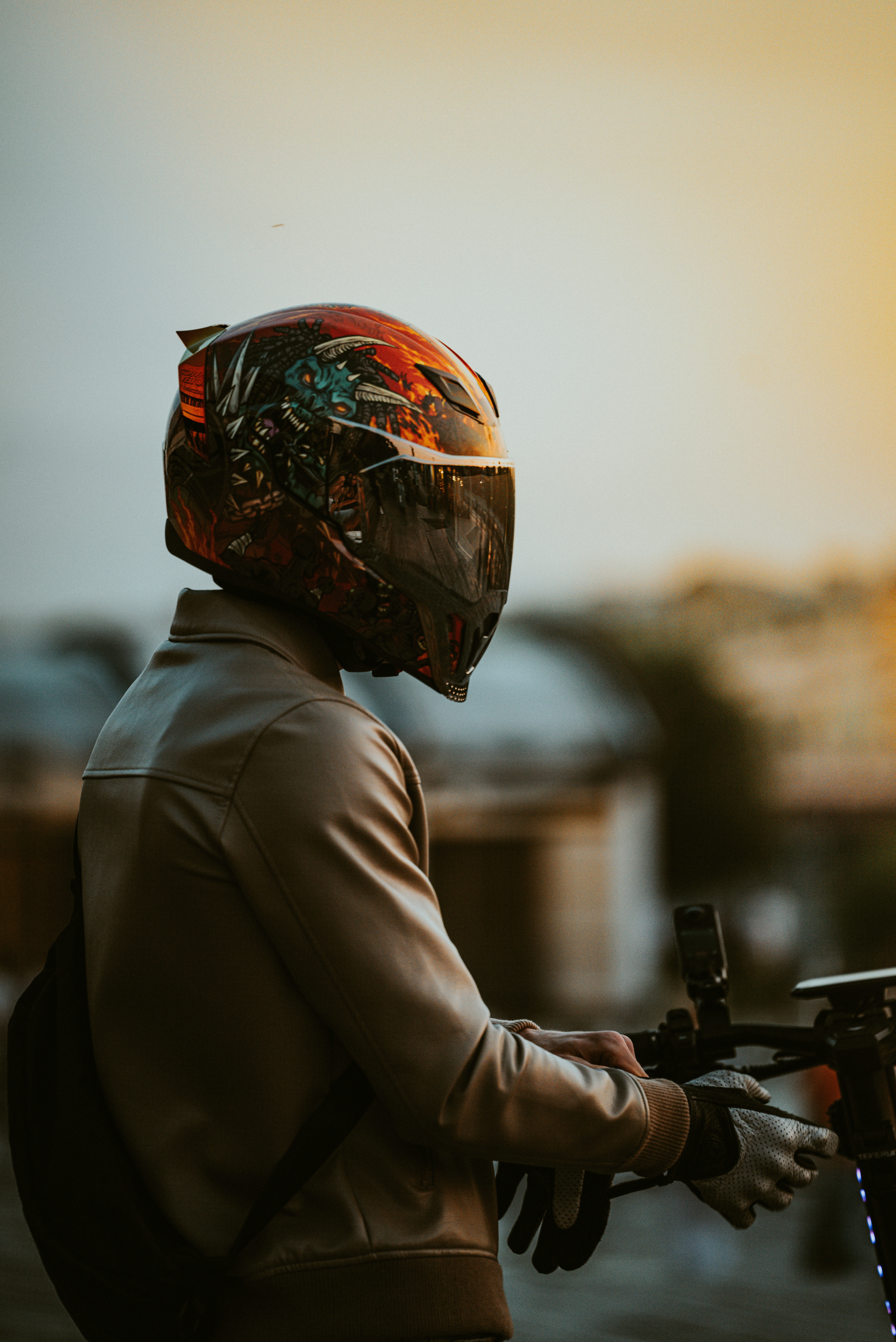 A person wears a helmet and stands outdoors.