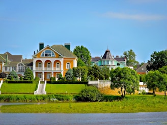 Beautiful houses sit next to a body of water.