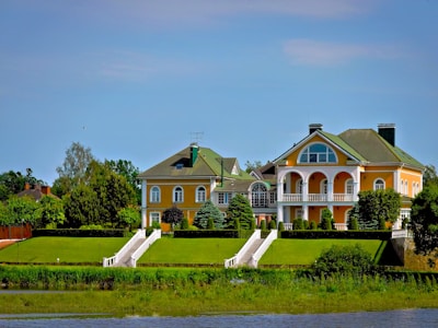 Elegant houses sit atop a grassy hill.
