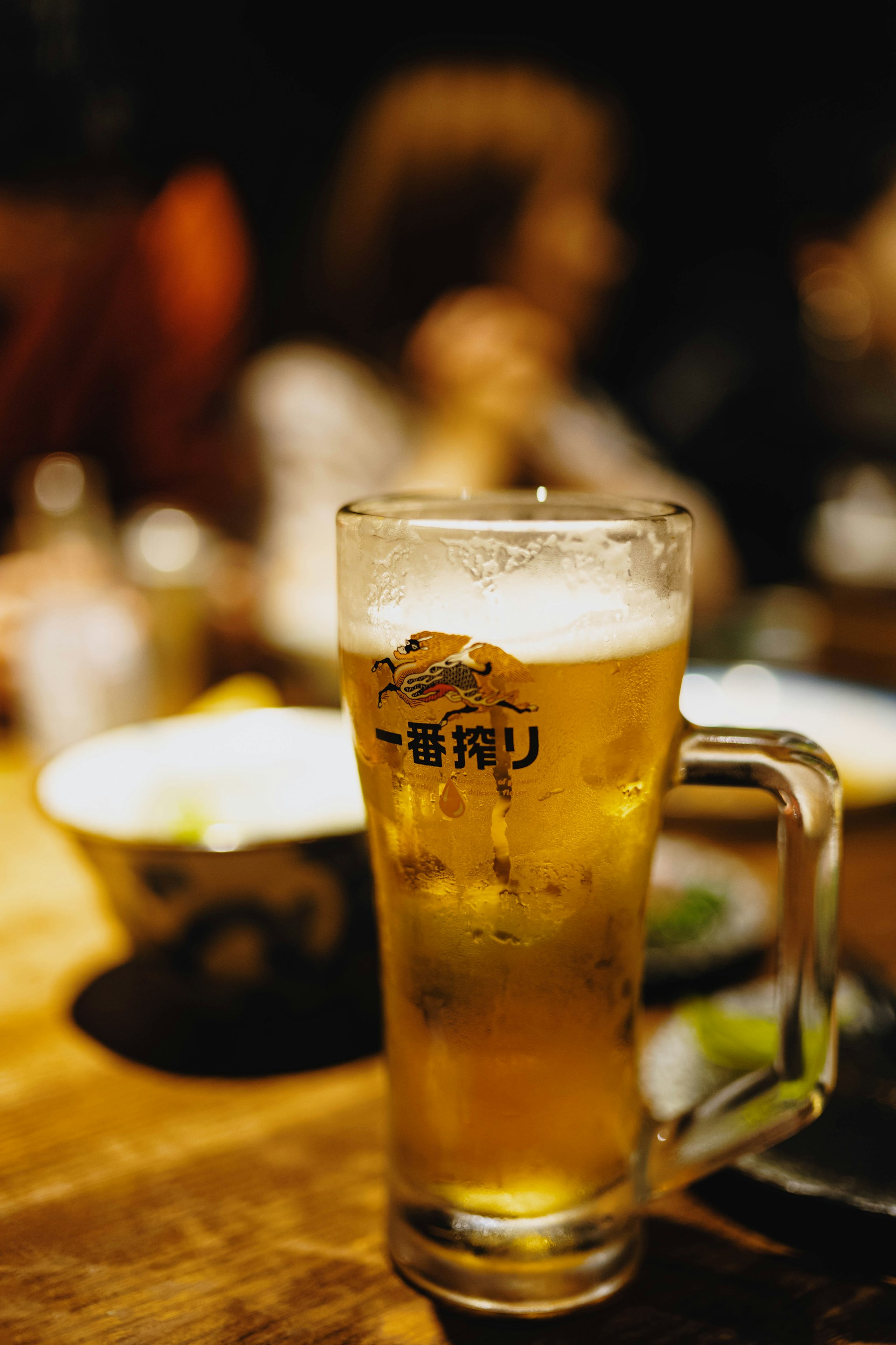 A glass of beer is on the table.