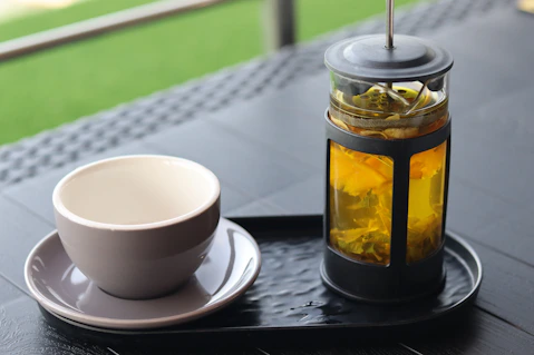Tea and a cup rest on a serving tray.