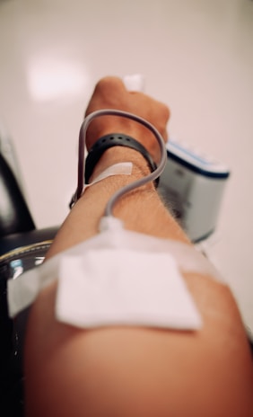 Someone's arm is being used for a medical procedure.