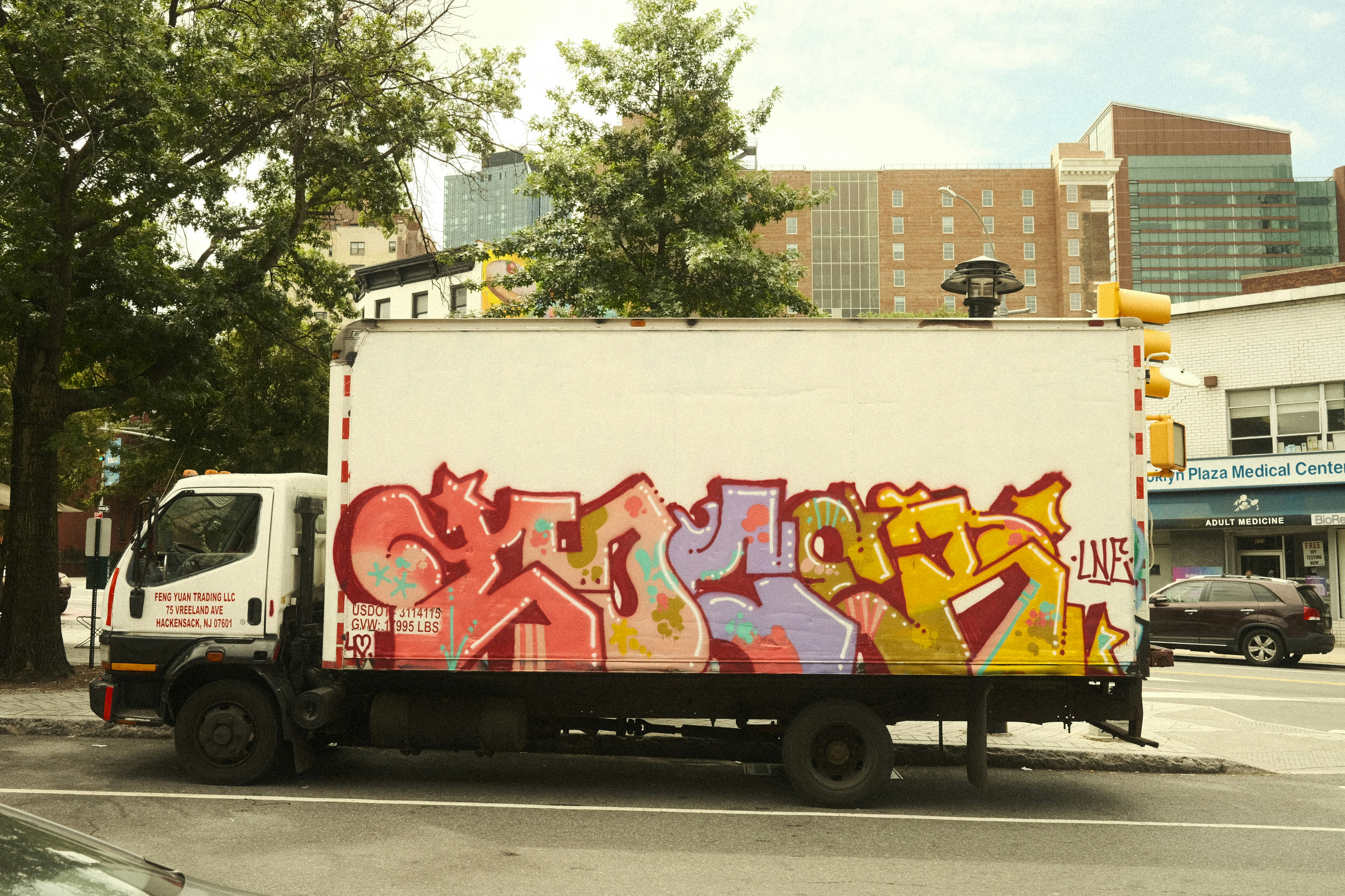 Graffiti art decorates the side of a delivery truck.