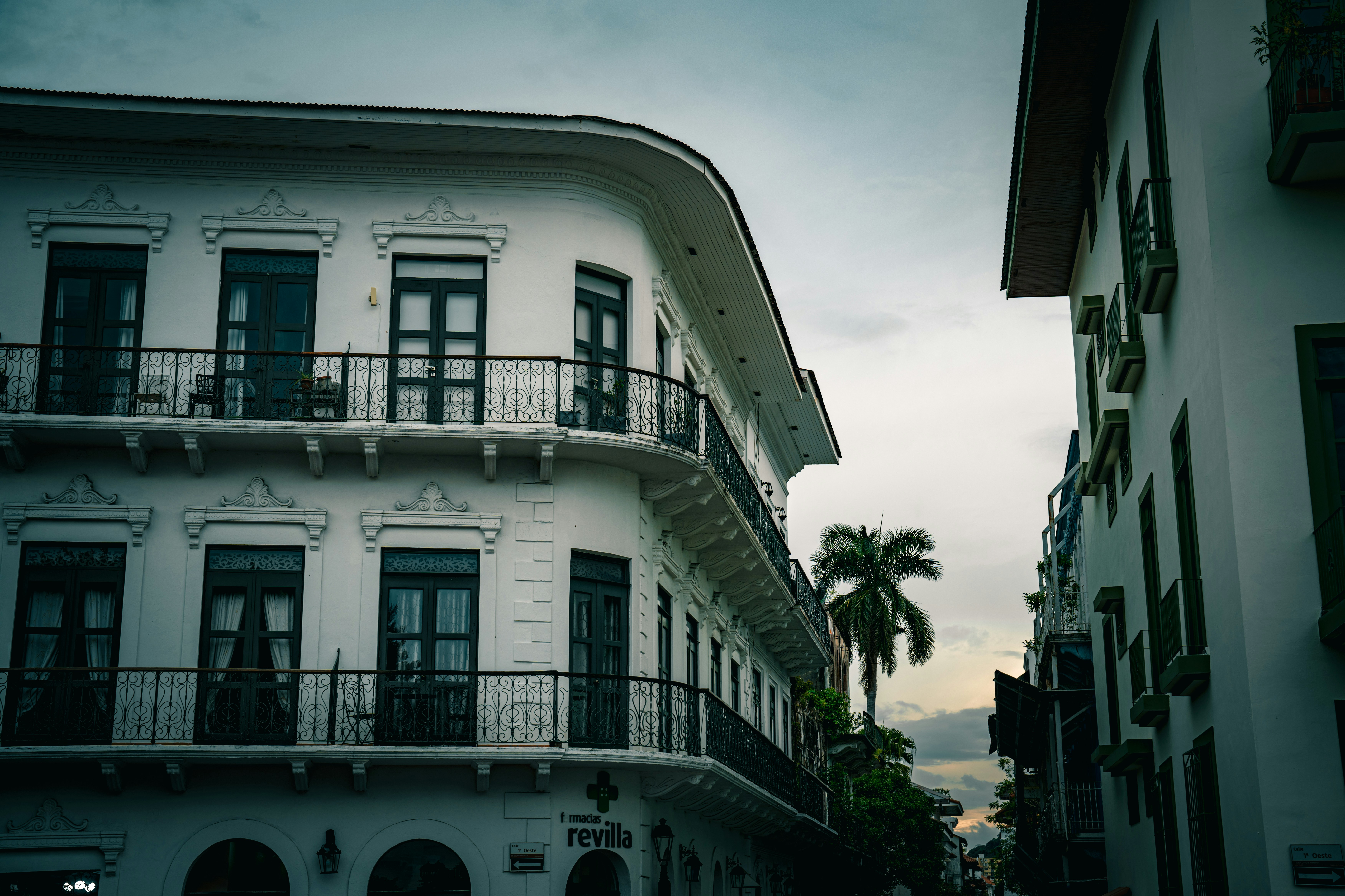 Elegant white buildings line a city street.
