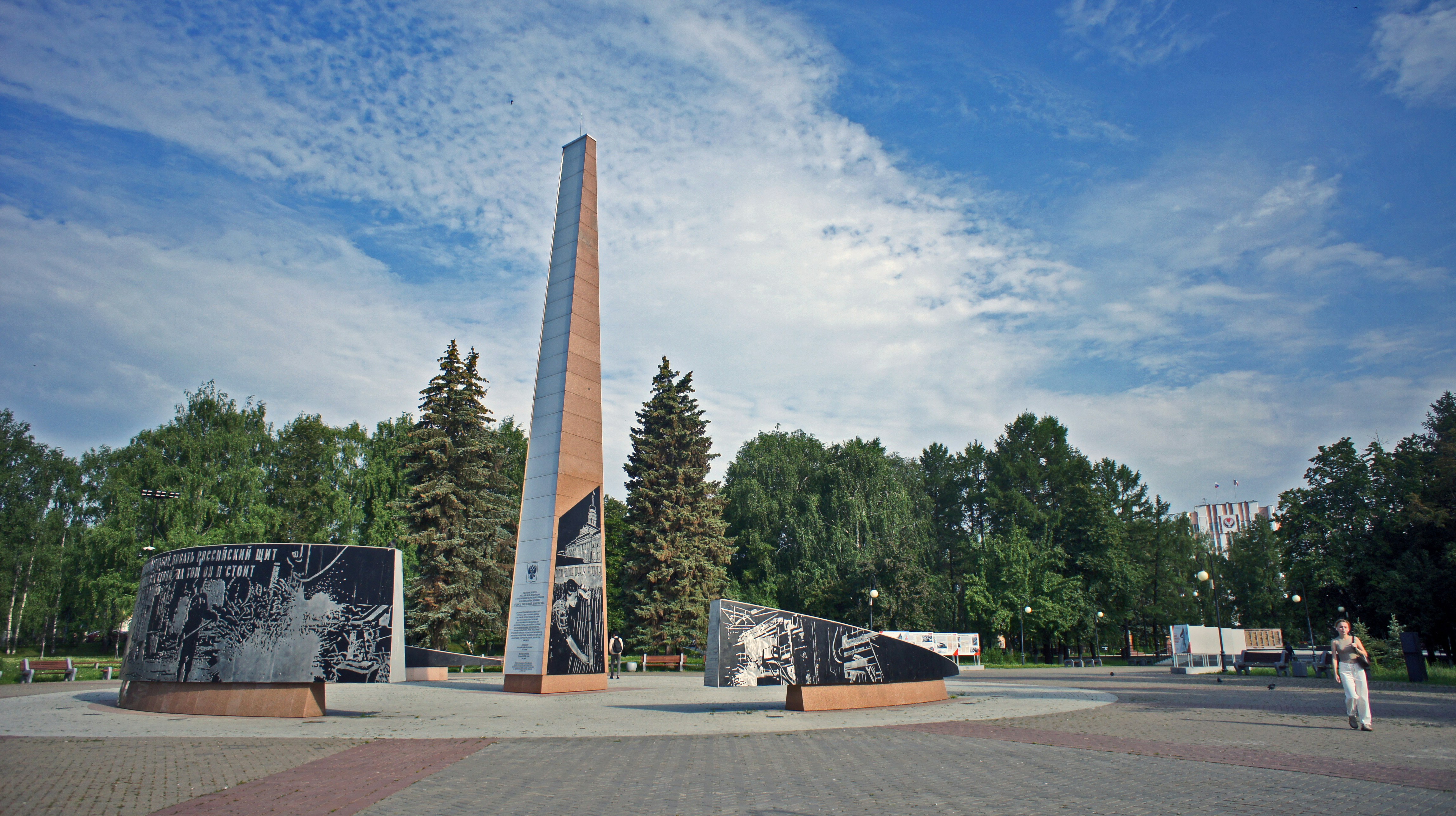 A memorial stands in a beautiful park.