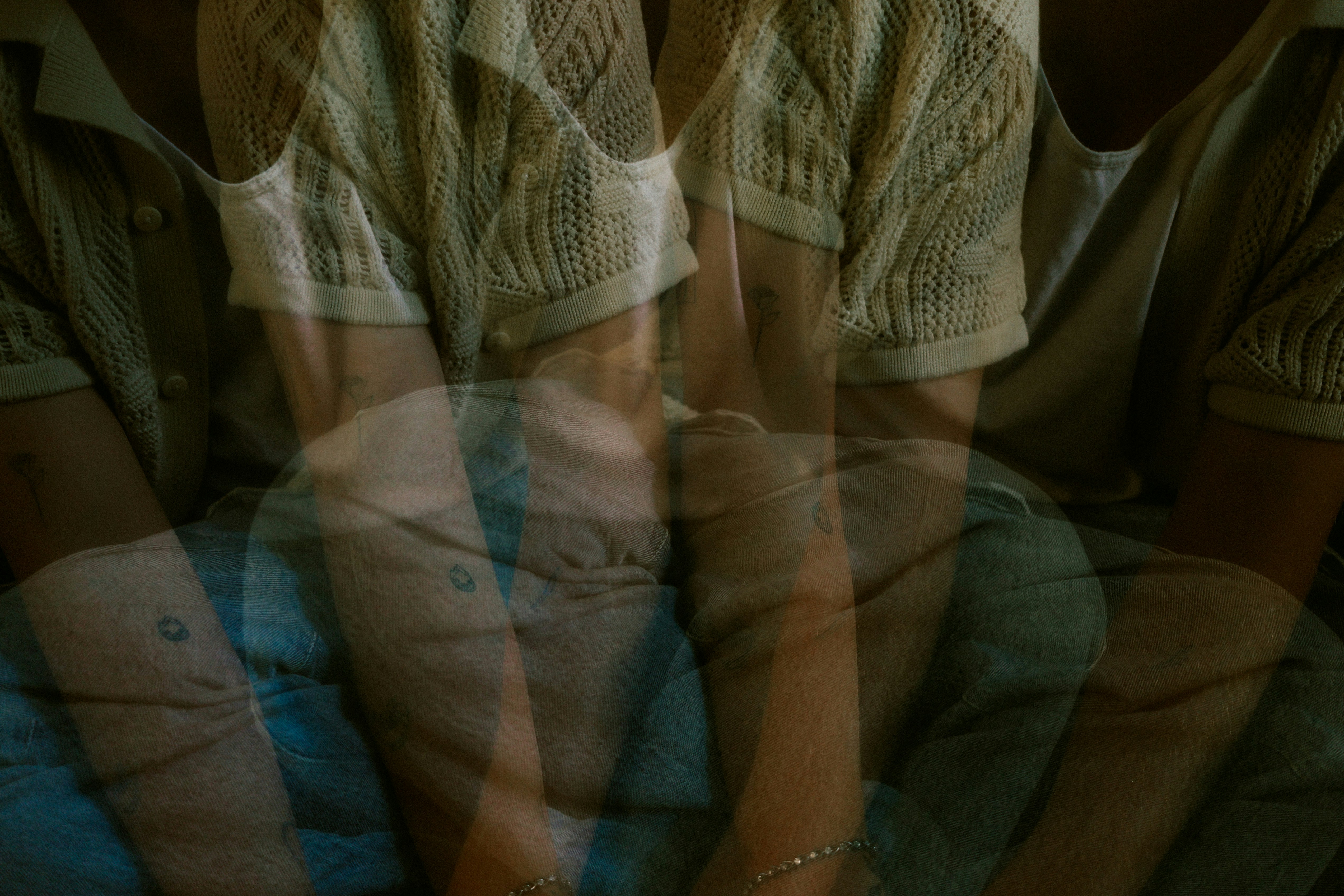 Multiple exposures of a person sitting down.