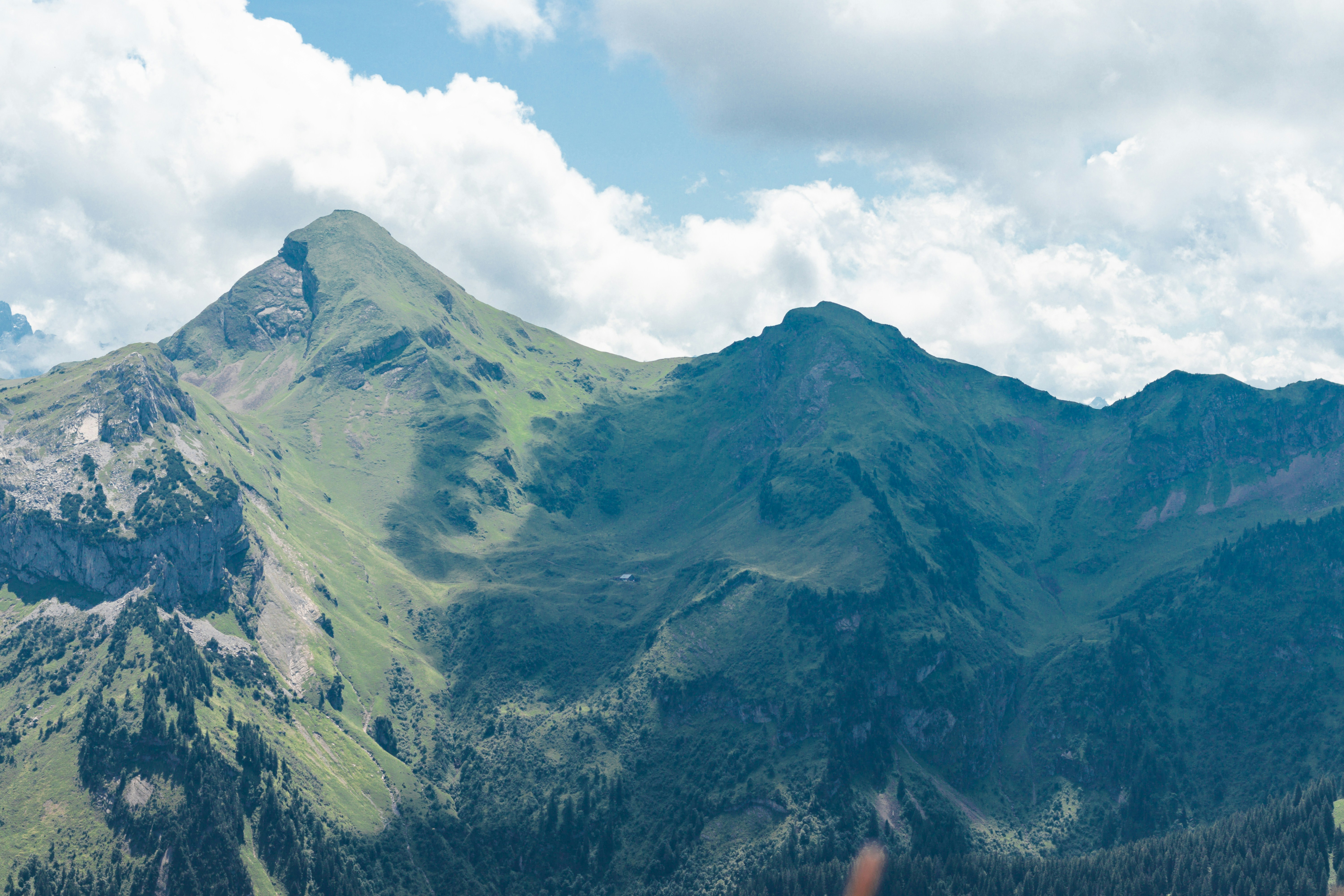 Mountains are visible under a cloudy, blue sky.