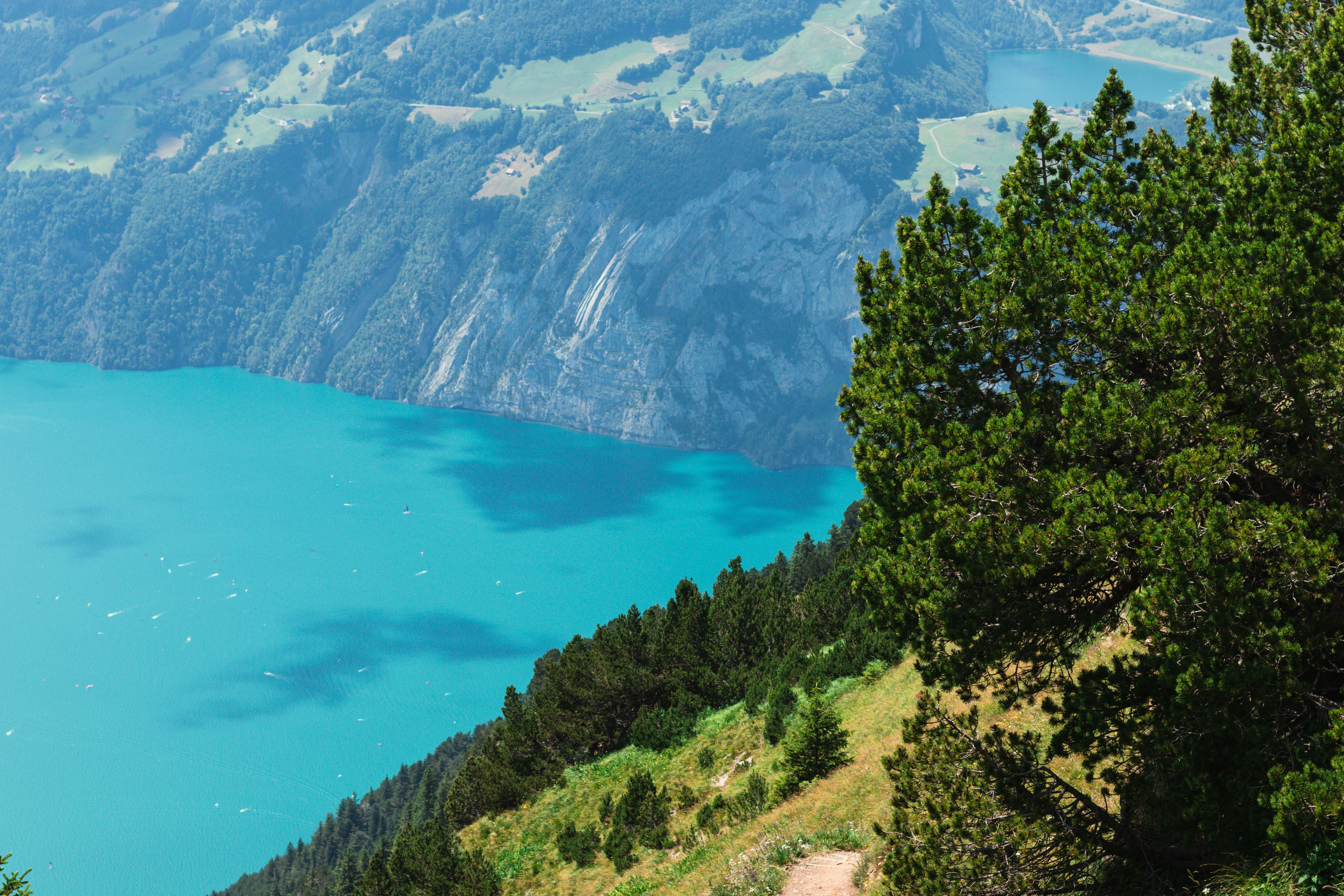 Turquoise lake and lush mountains create a scenic vista.