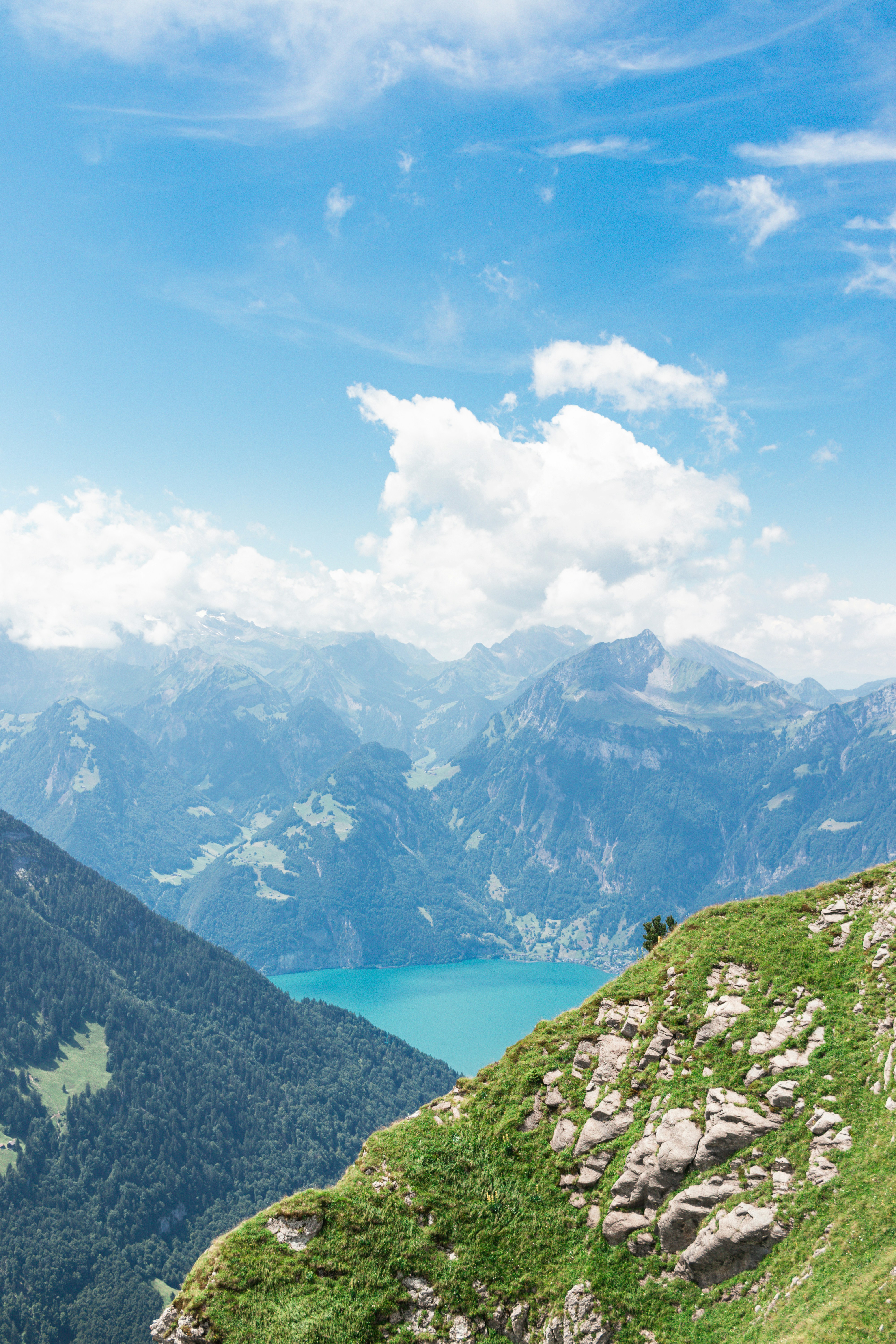 Mountains and a lake under a bright blue sky.