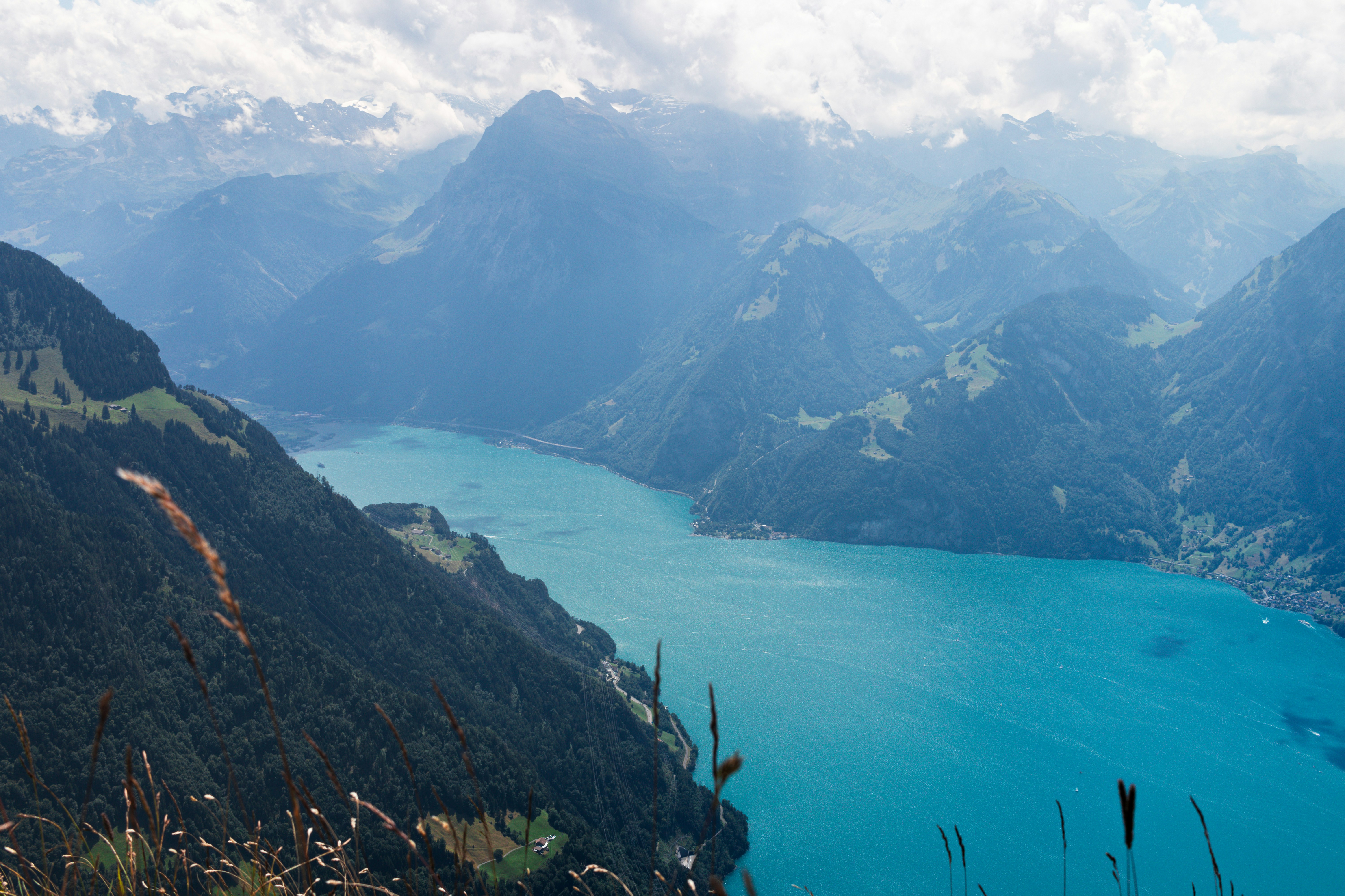 Vast lake and mountains stretch into the distance.