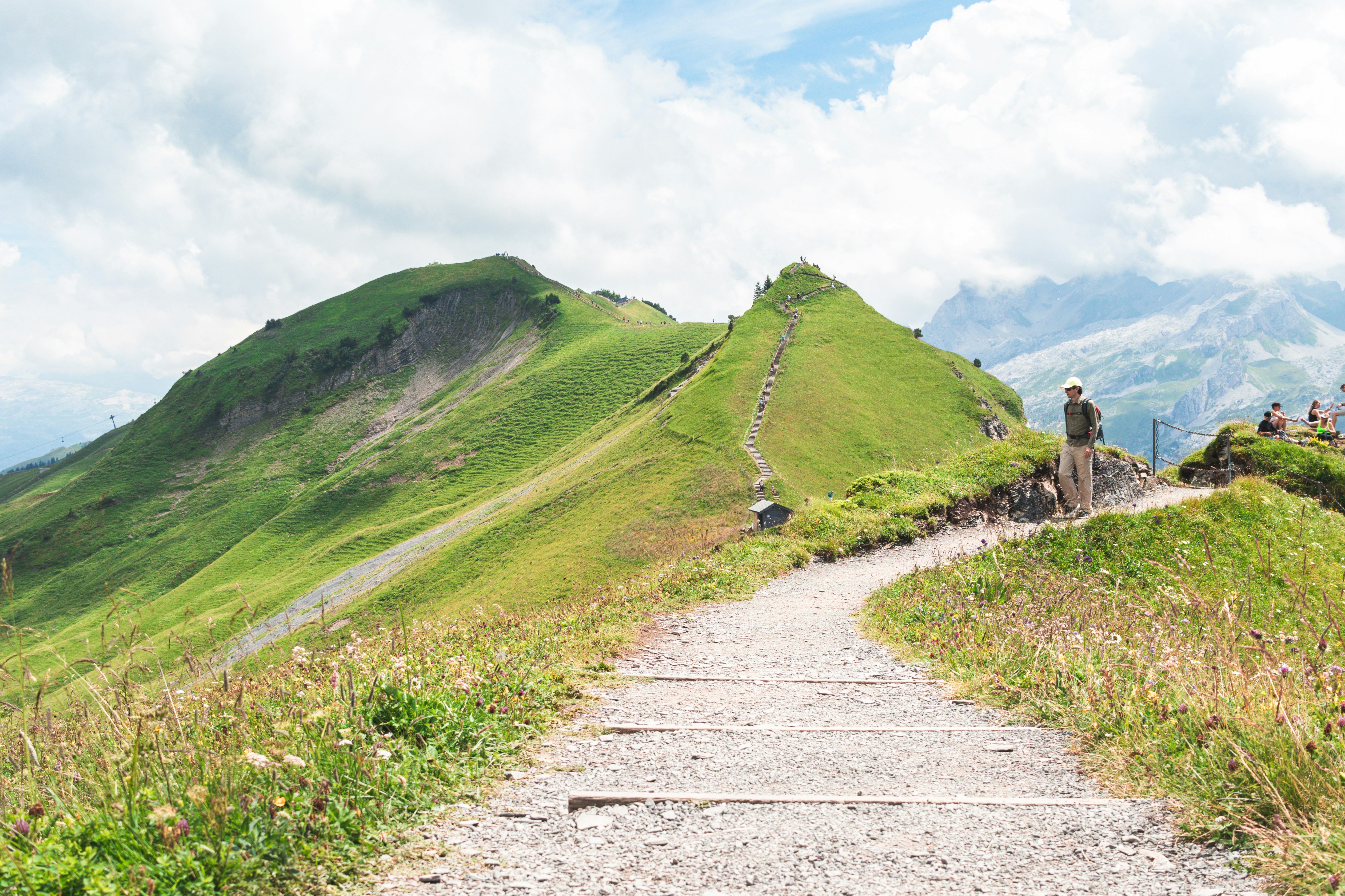 A winding path leads across a green mountain.