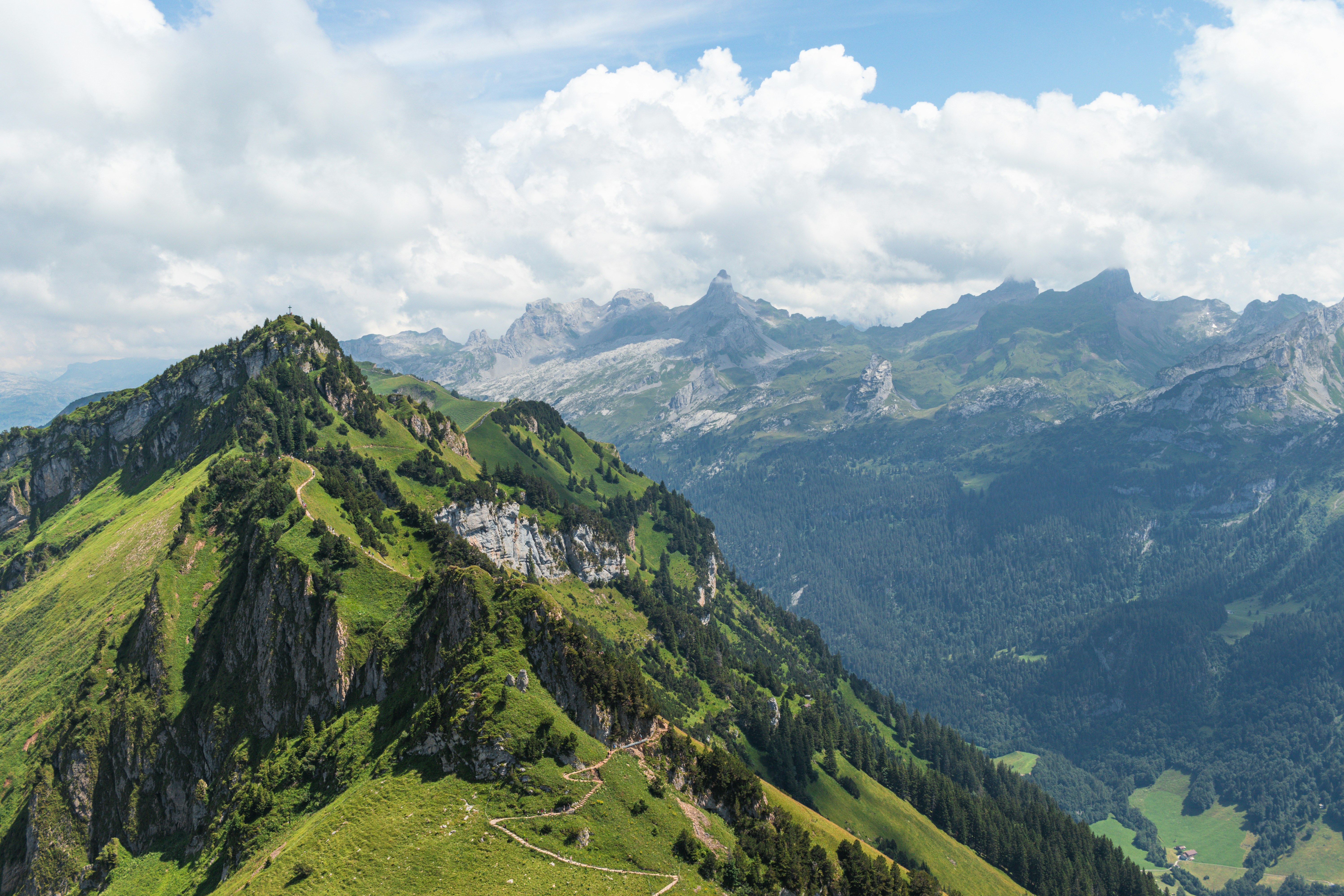 Rolling green mountains and cloudy skies.