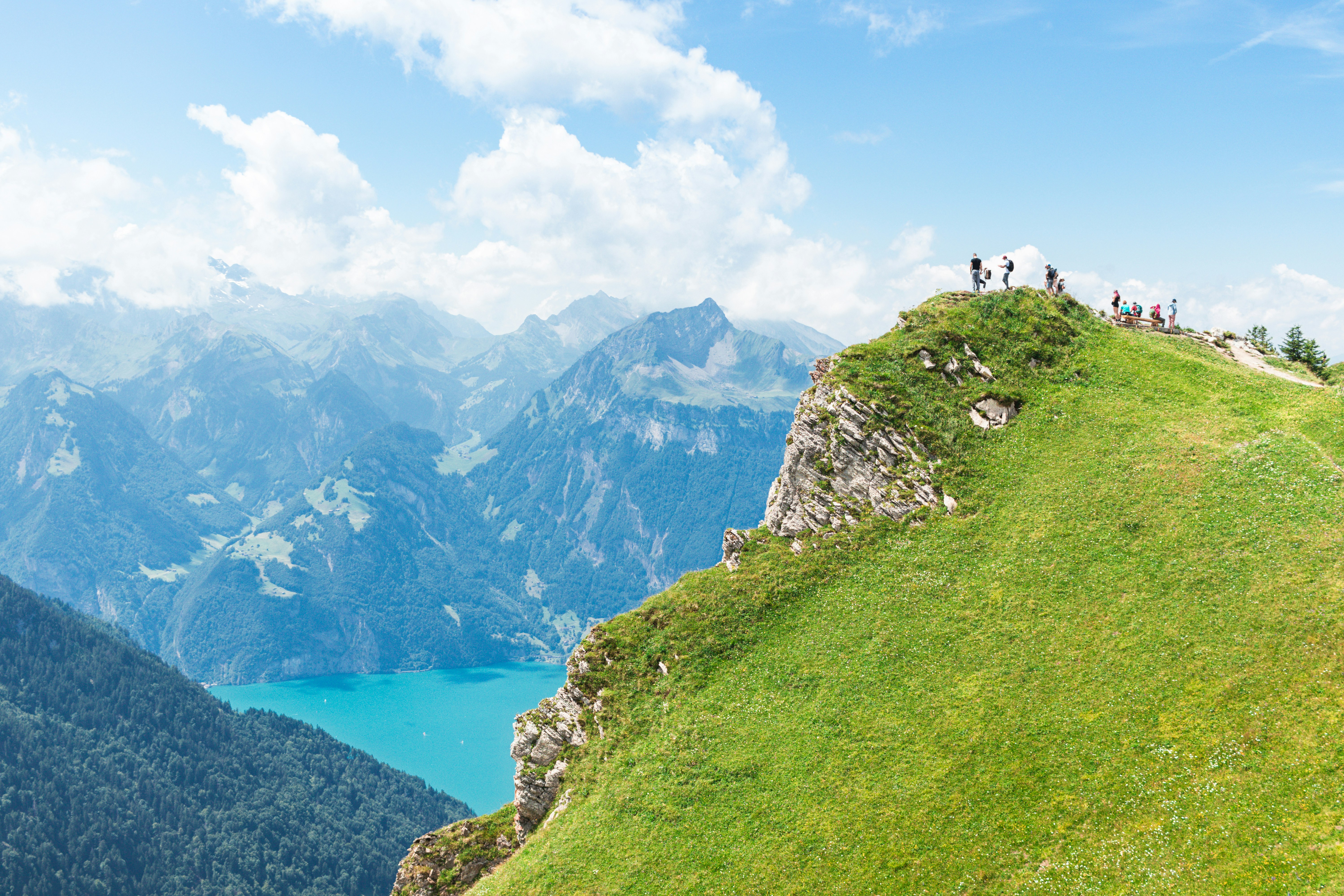 People enjoy the mountain view on a sunny day.