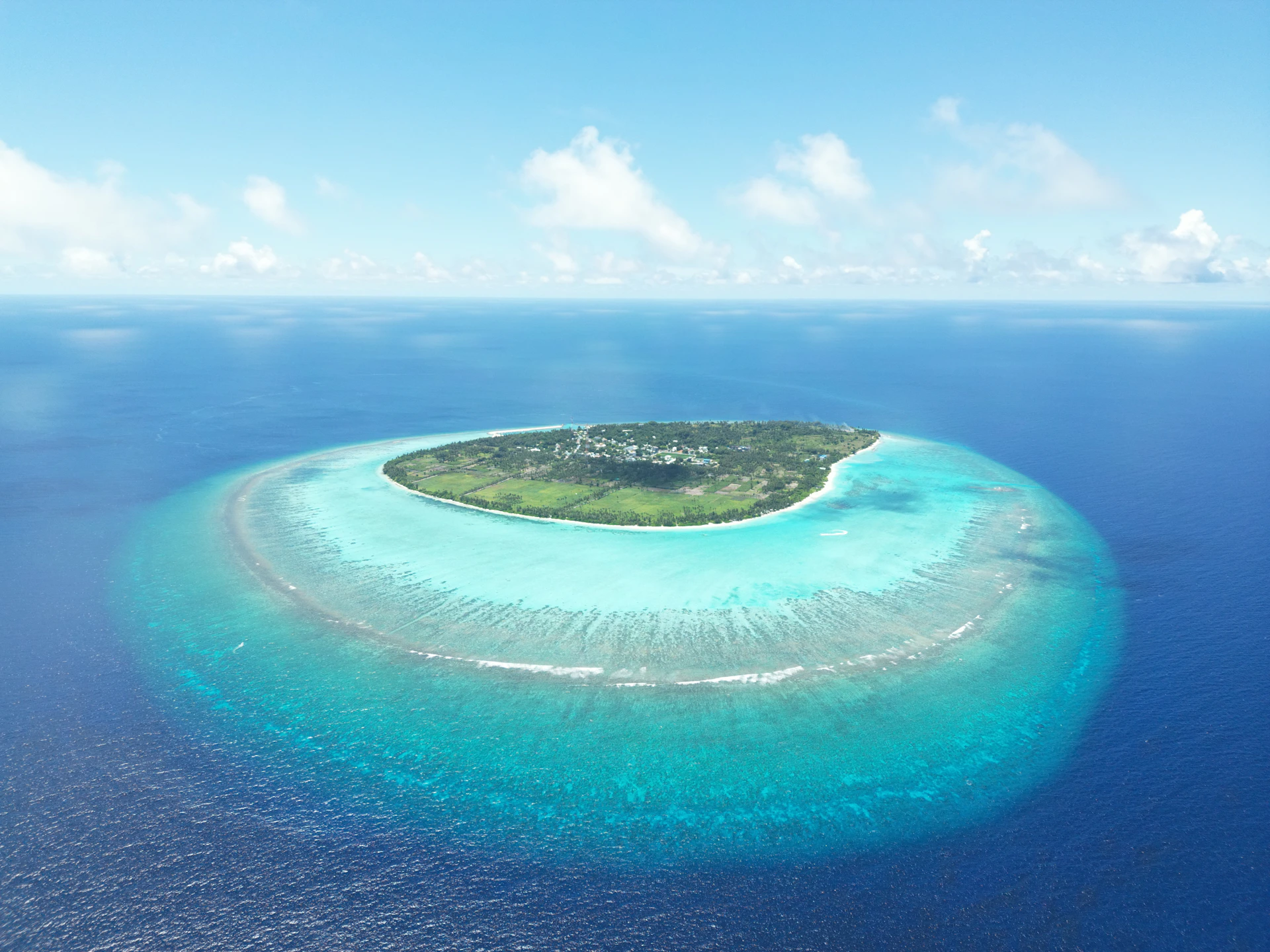 A beautiful island is surrounded by turquoise waters.