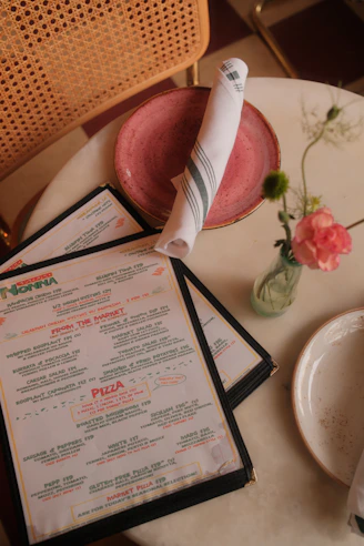 A restaurant table is set with a menu.