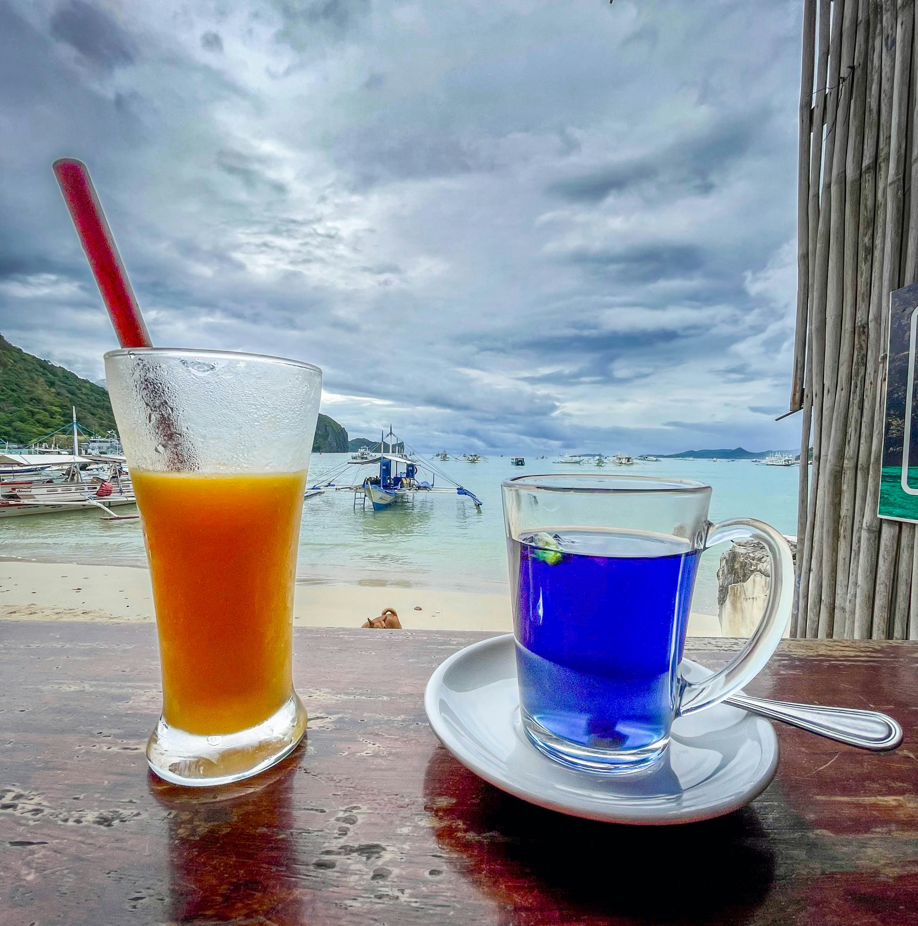 Drinks on a table with a beautiful beach view.