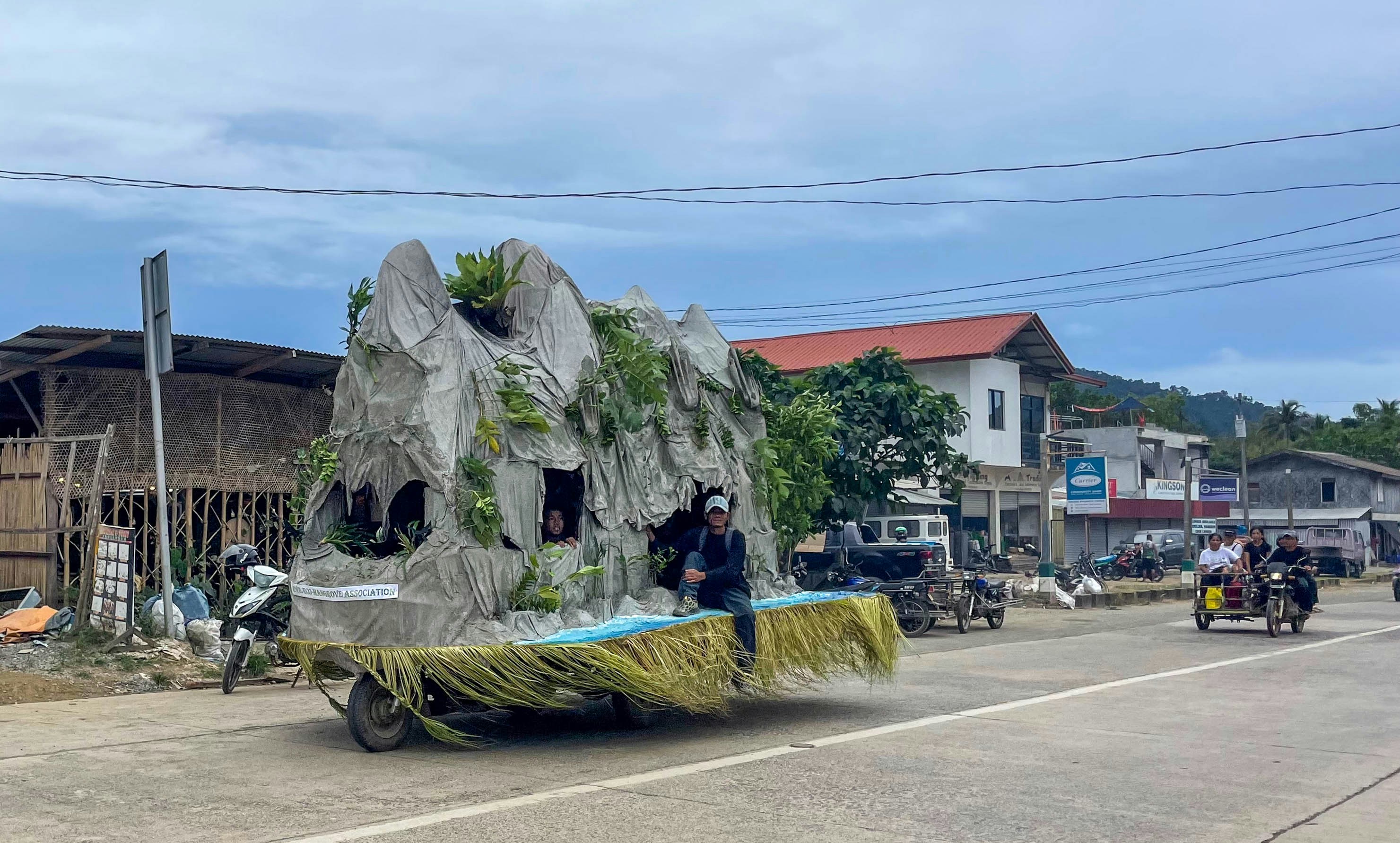 A decorated vehicle drives down a road.