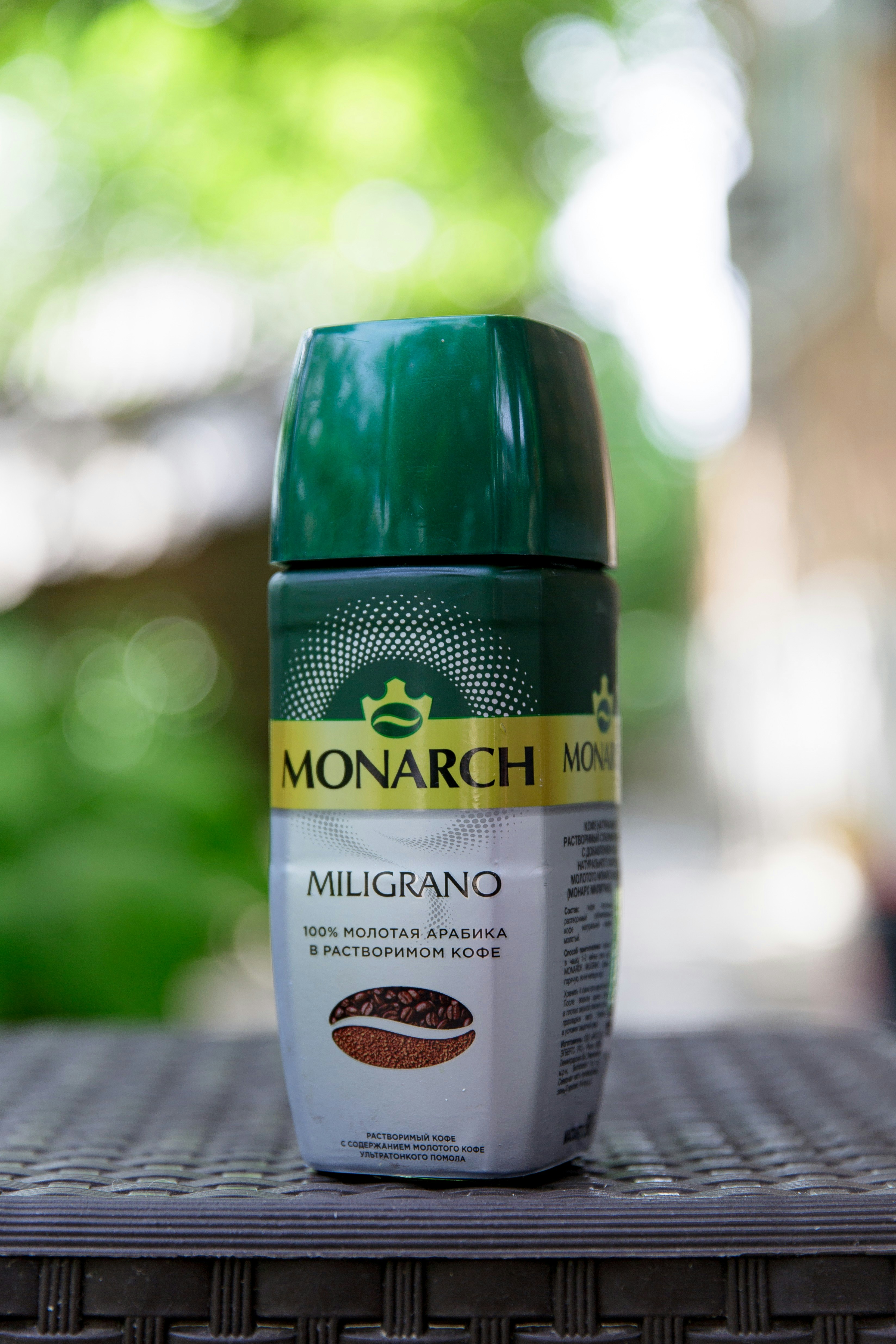 A monarch coffee container is shown outdoors.