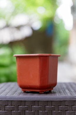 A brown plant pot sits on a table.