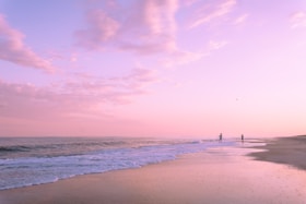 Pink sunset over a peaceful beach.