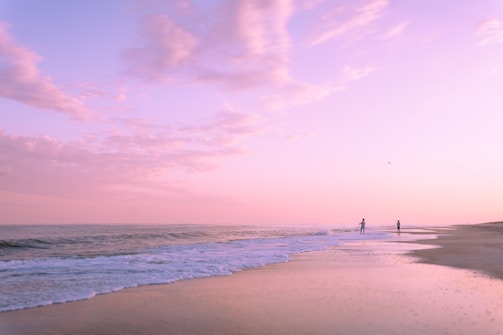 Pink sunset over a peaceful beach.