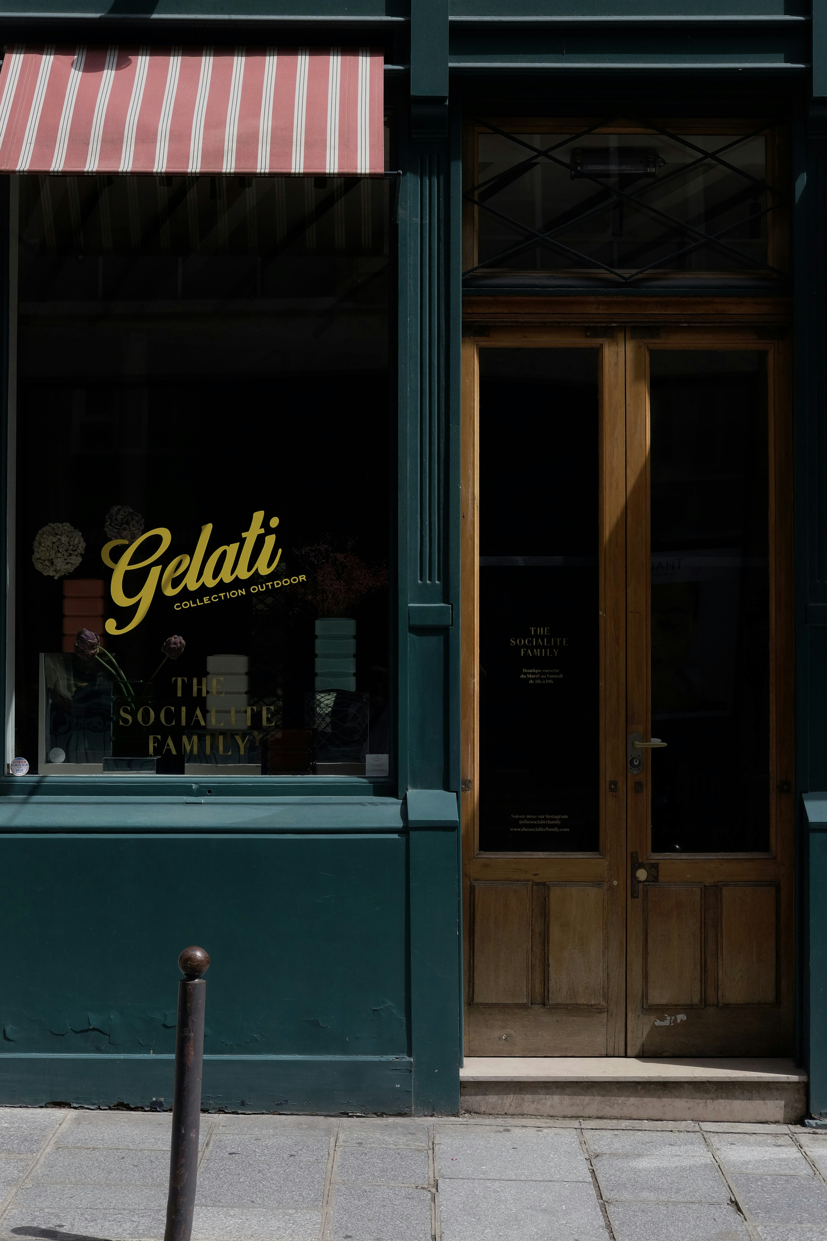 A gelati shop with a striped awning.
