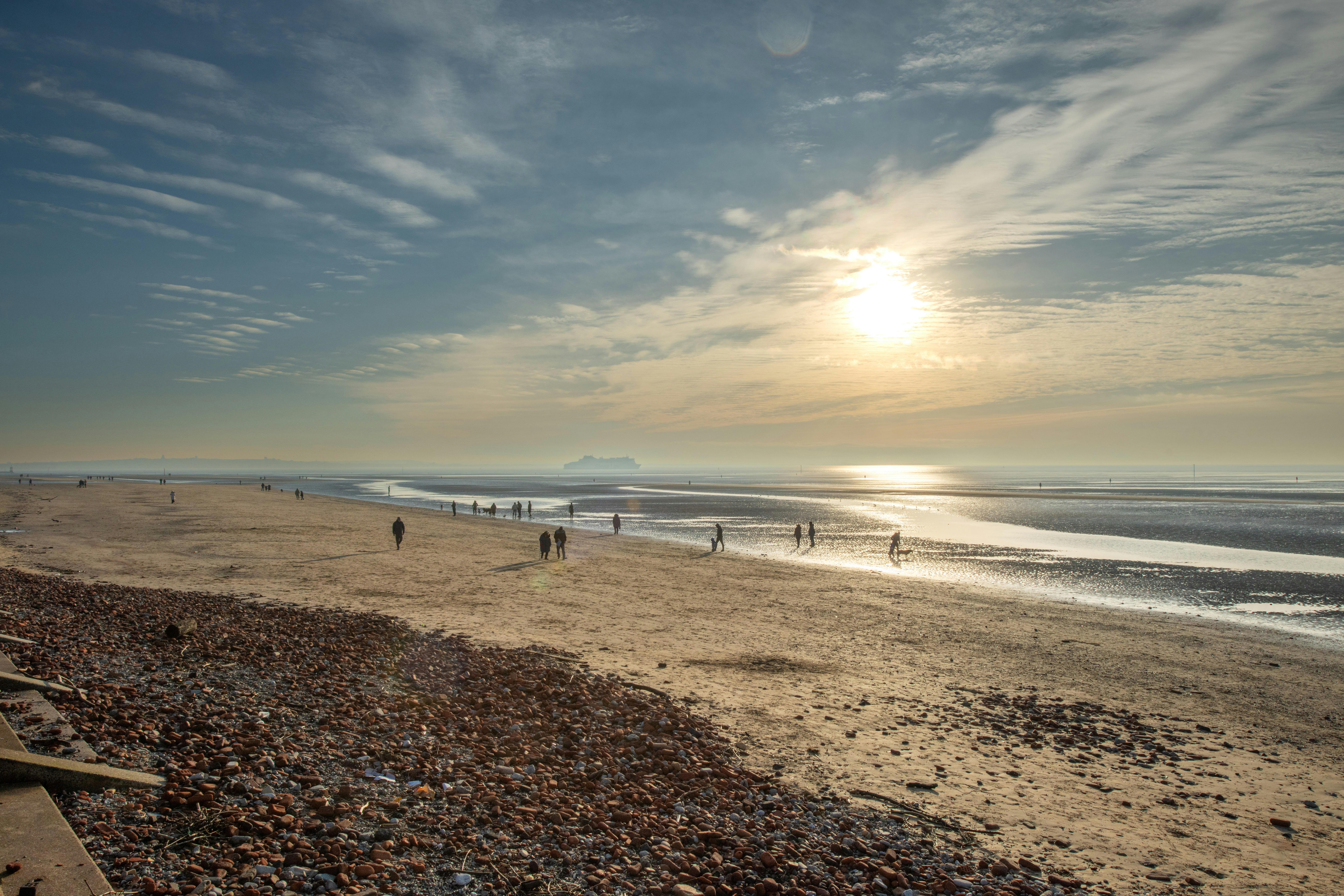 People enjoy a bright, sunny day at the beach.