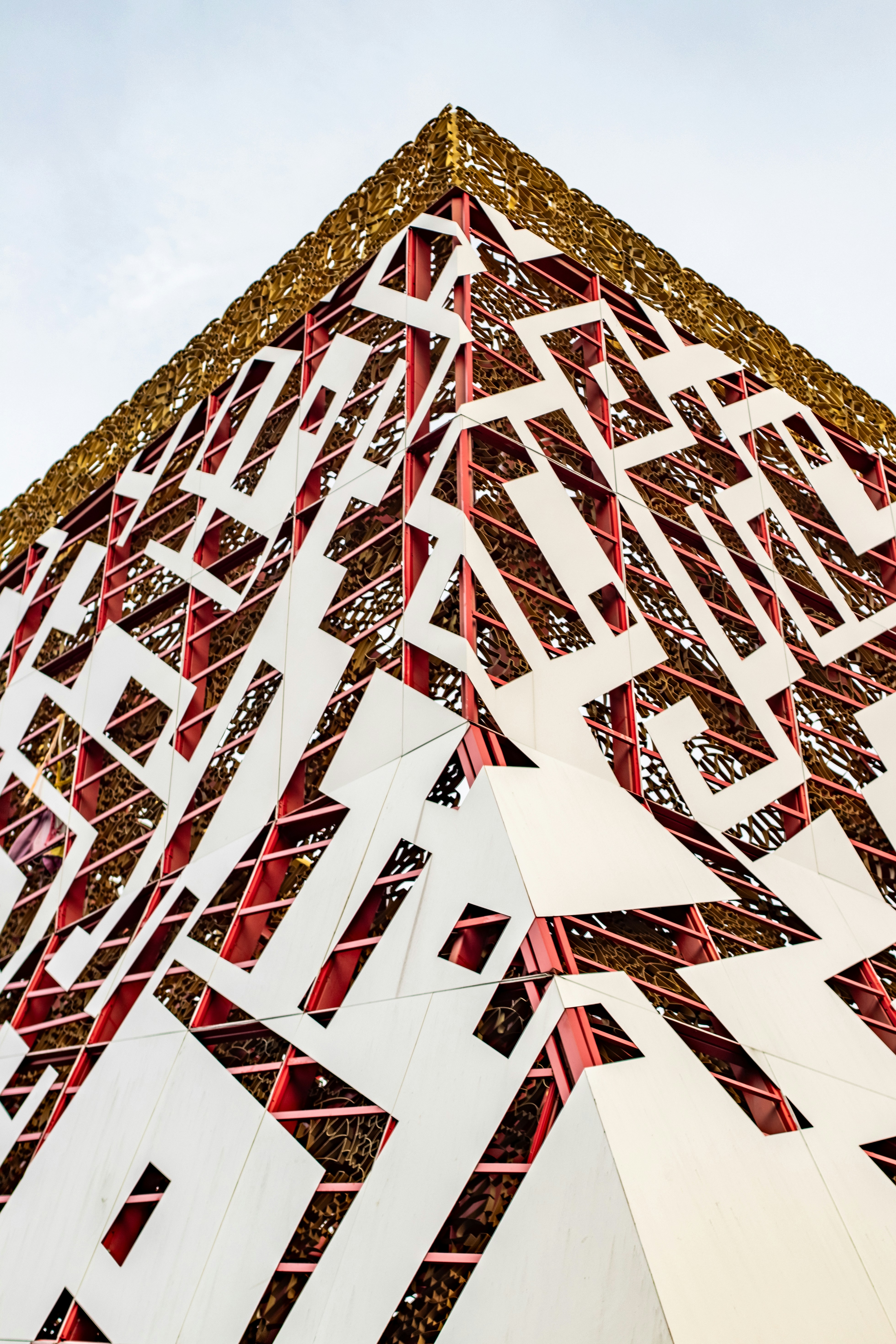 Modern pyramid-shaped building with intricate designs