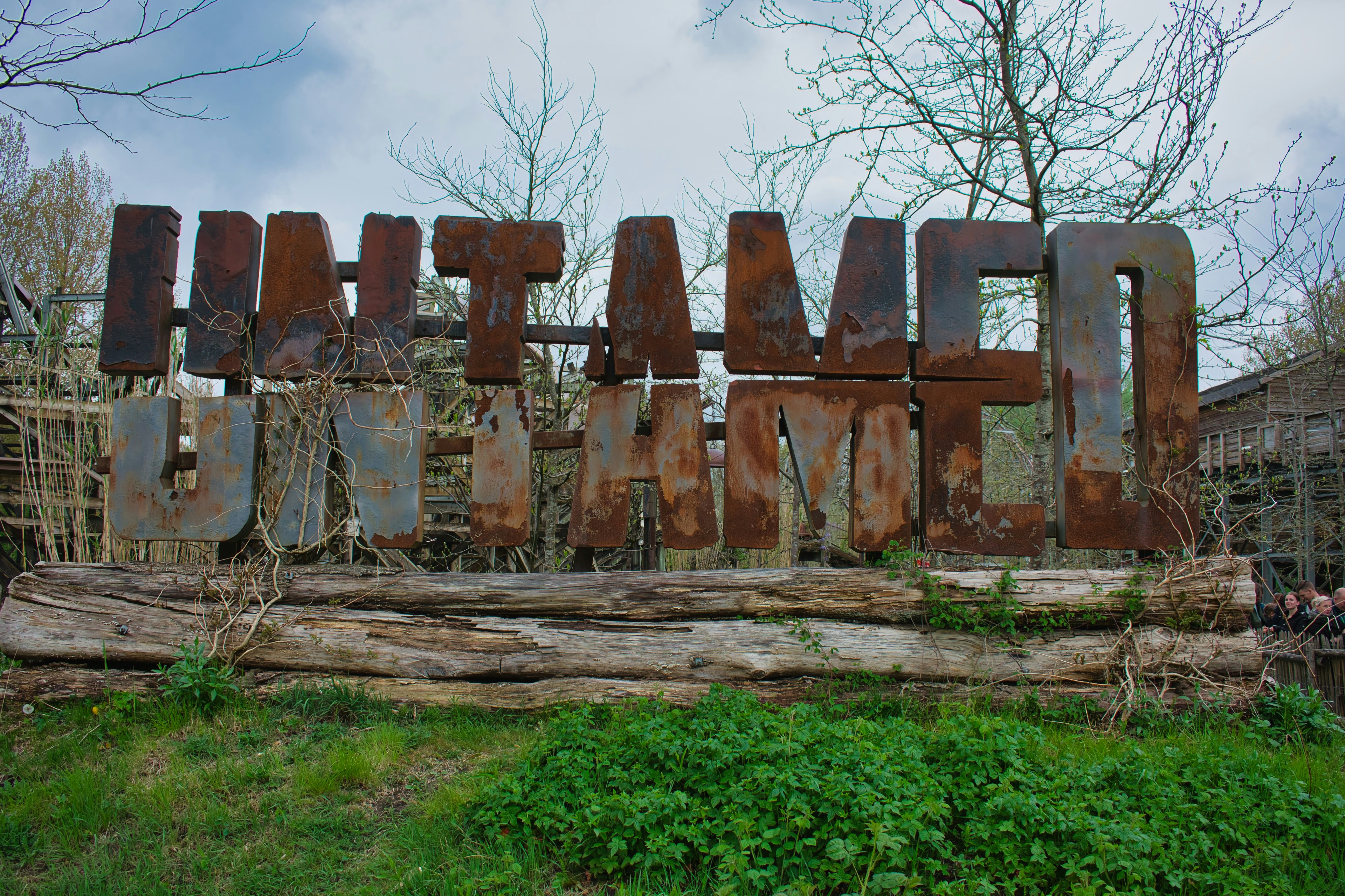 The sign reads "untamed" in large, rusty letters.