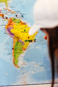A person examines a map of south america.