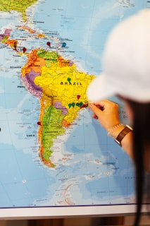 Someone points to a map of south america.