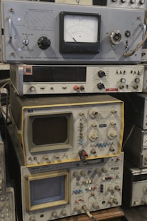 Several vintage electronic instruments are stacked together.