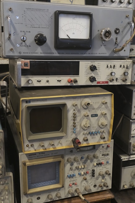 Several vintage electronic instruments are stacked together.