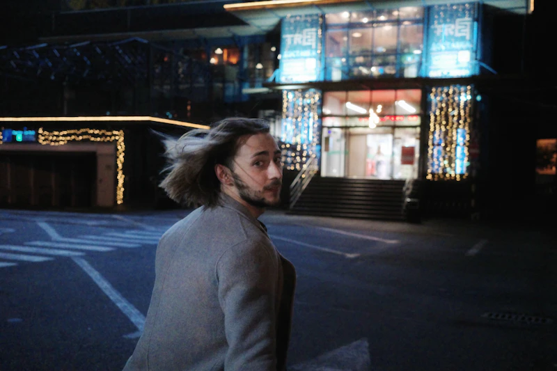 confident man looking back on a city walk