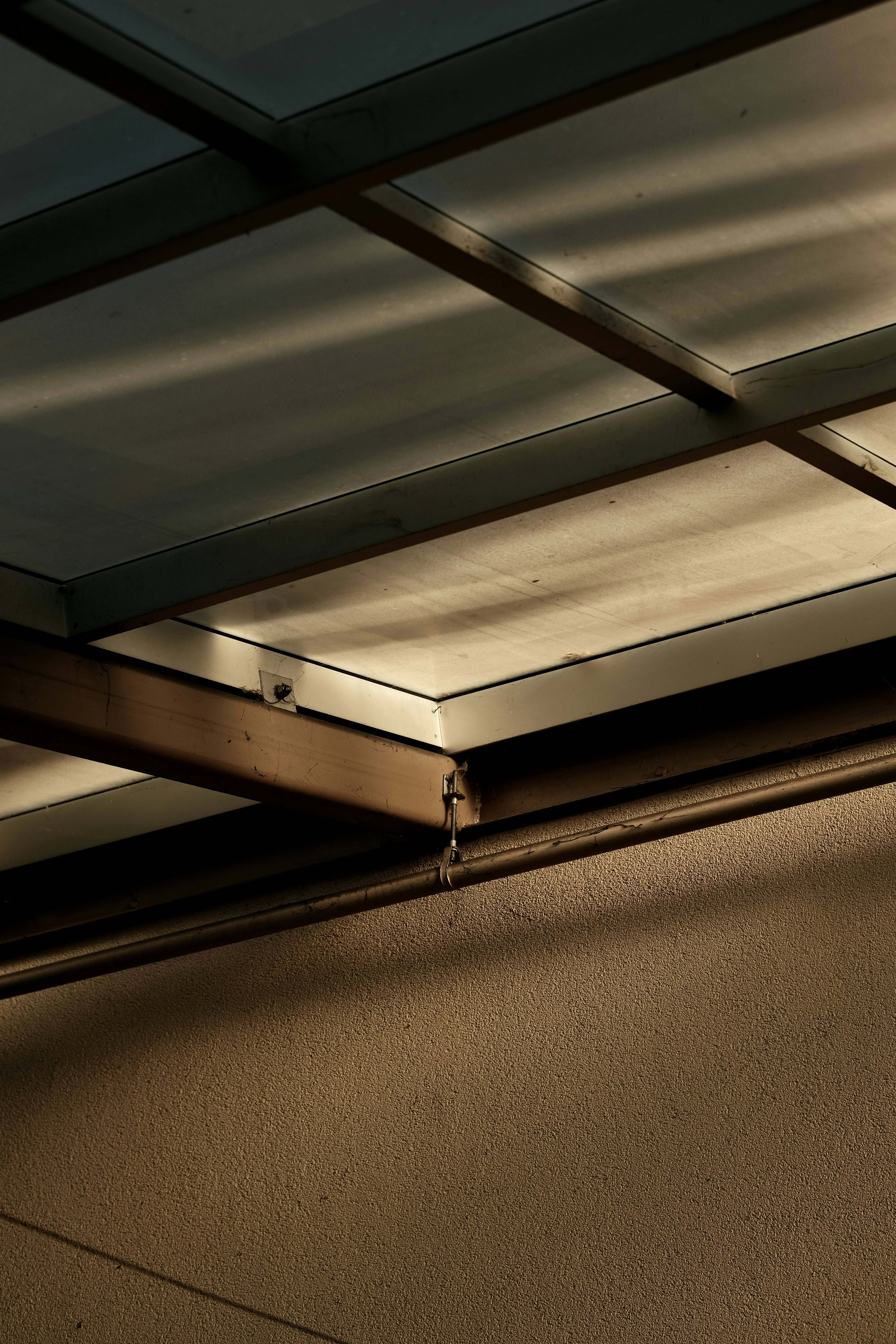 Overhead view of ceiling with sunlight and shadows