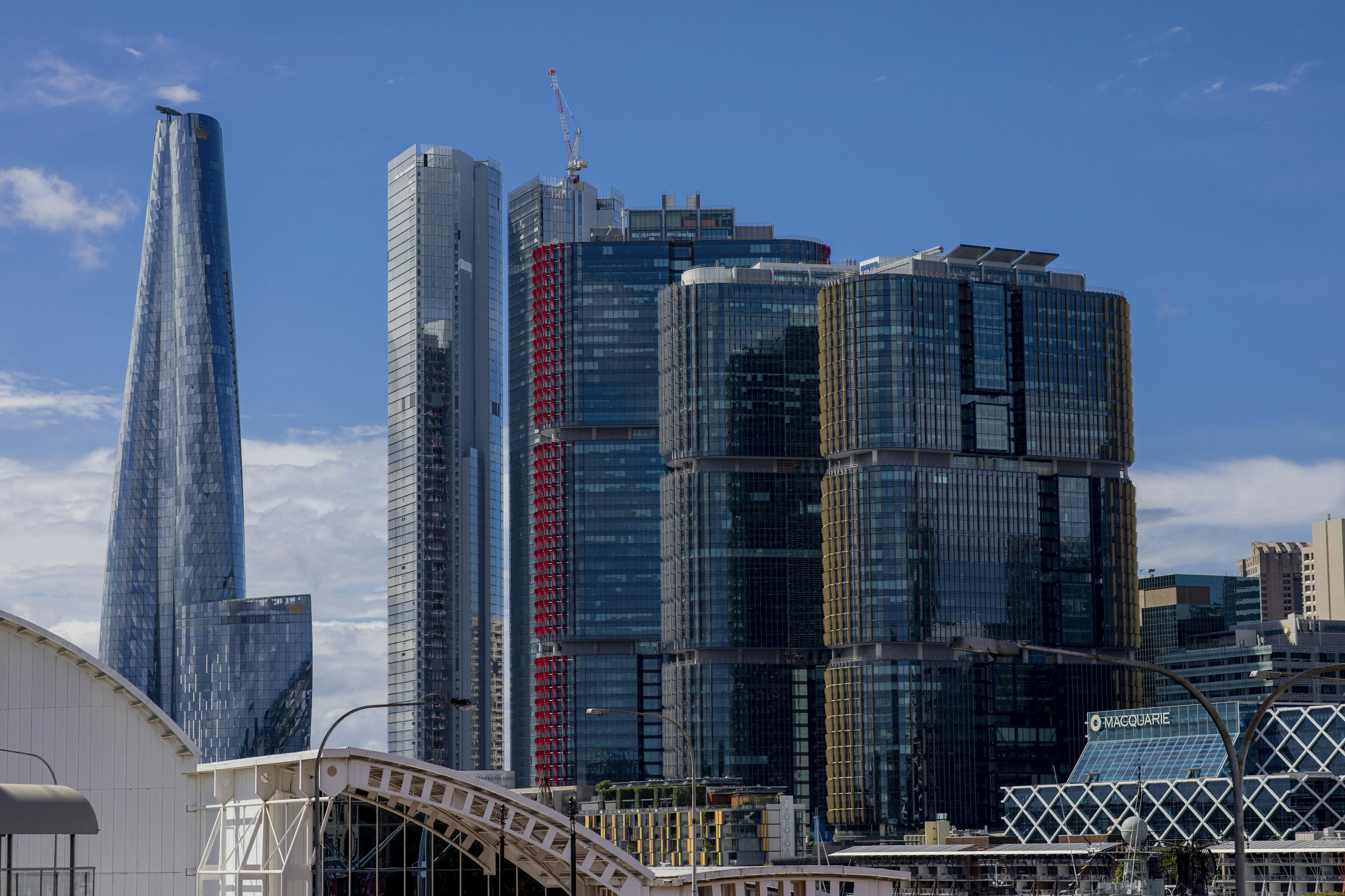 Skyscrapers stand tall against a bright blue sky.