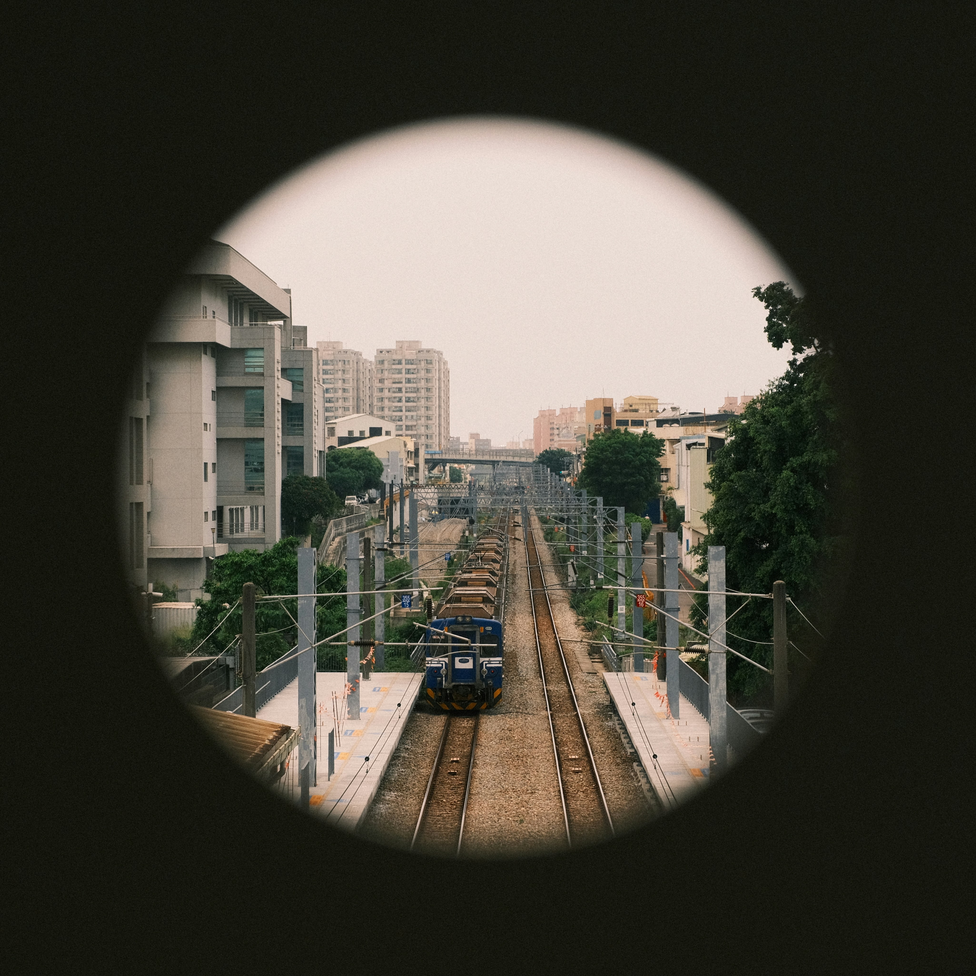 Train traveling through a city from a unique viewpoint.
