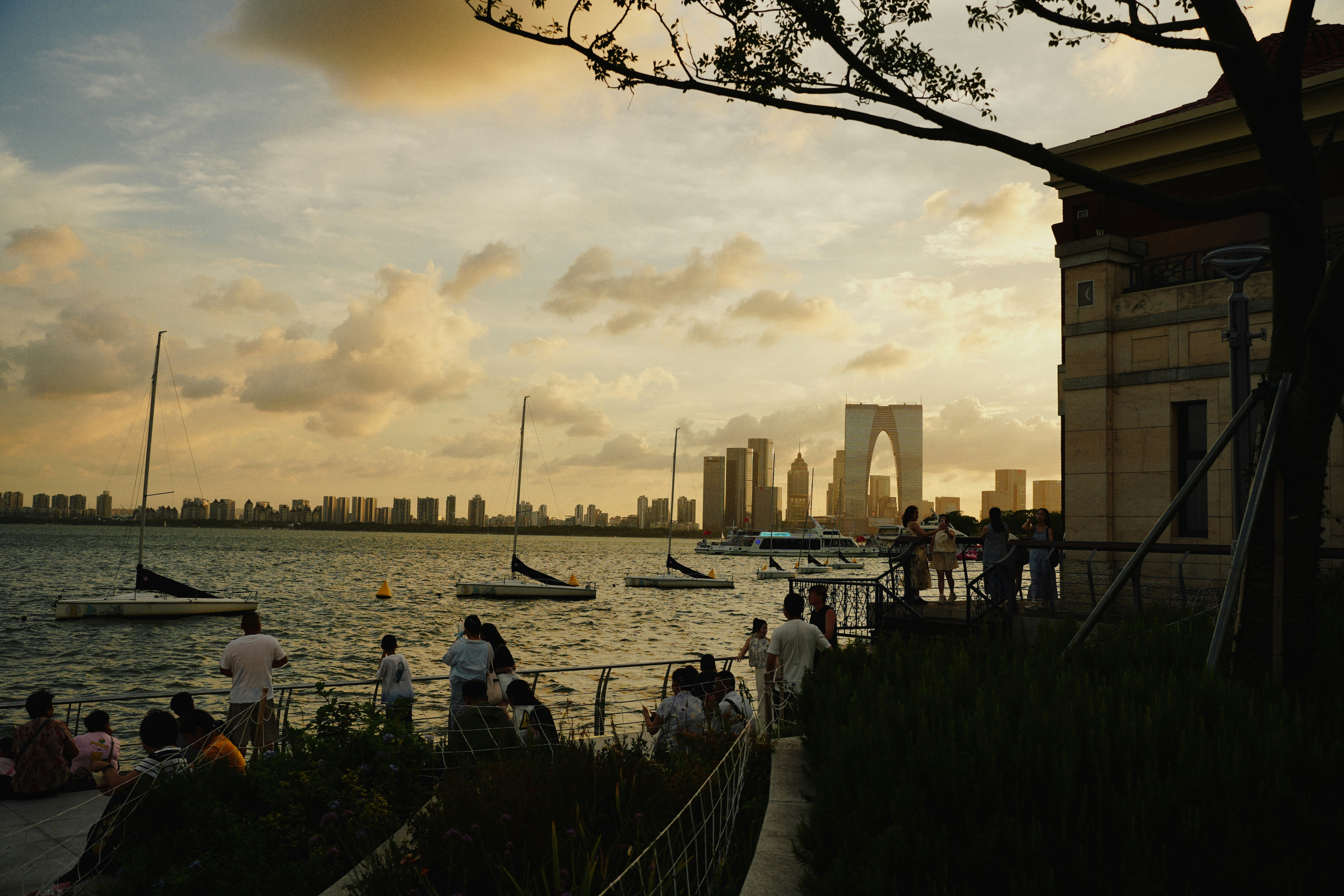 People enjoy a sunset view over a lake.