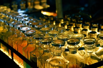 Bottles are aligned on a conveyor belt.