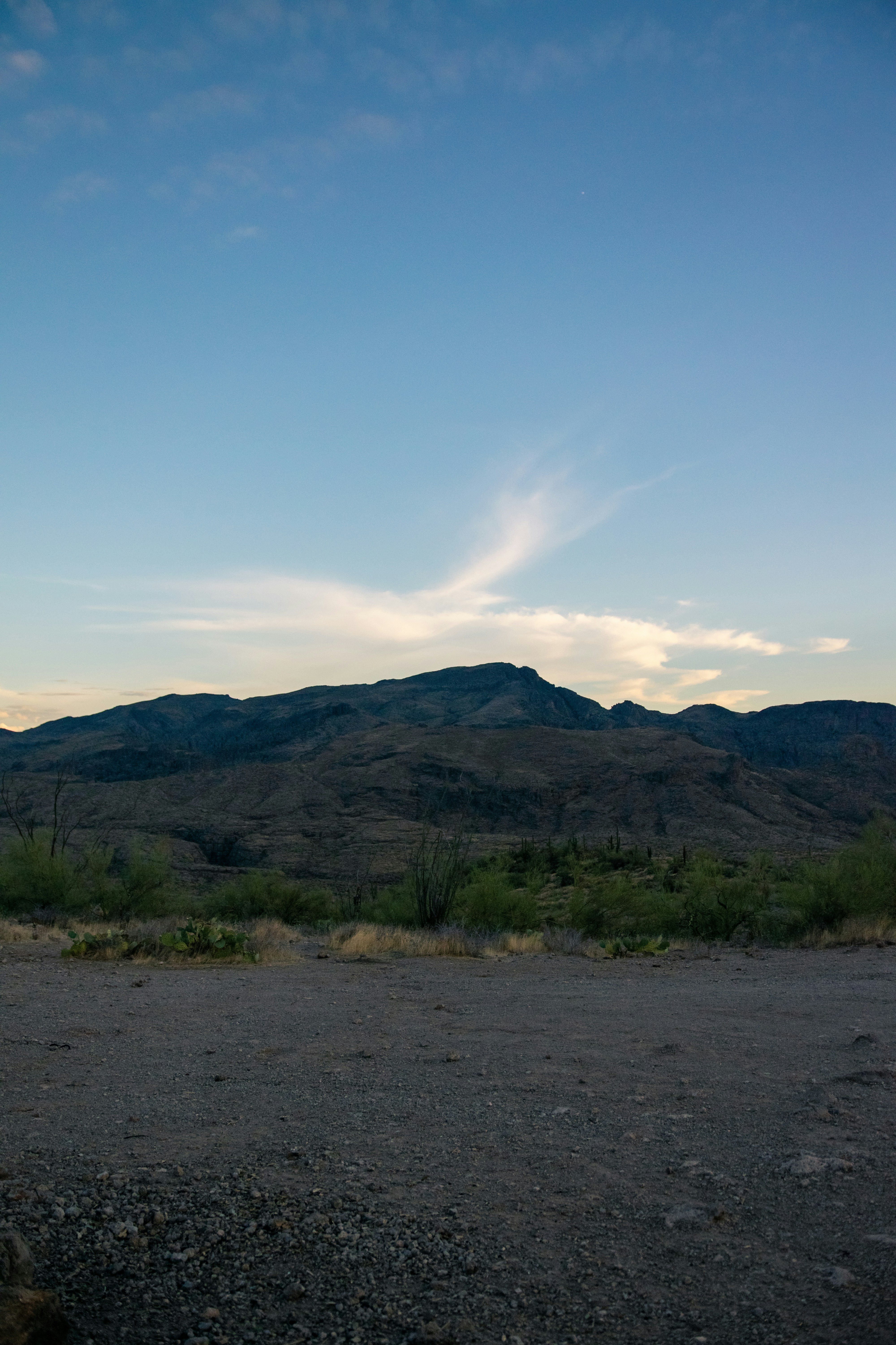 Mountains and a sky with wispy clouds.