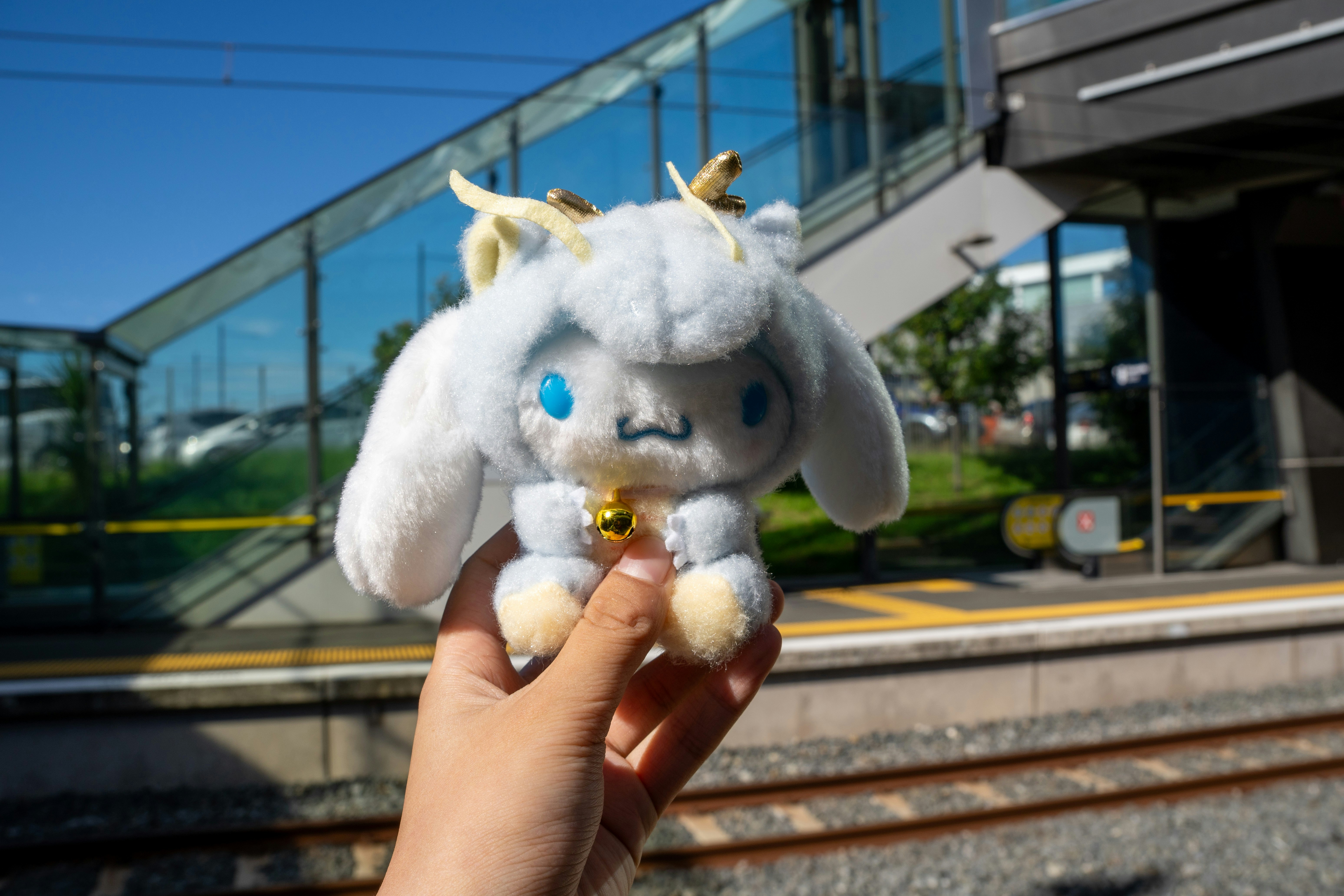 A person holds a cute plush toy.