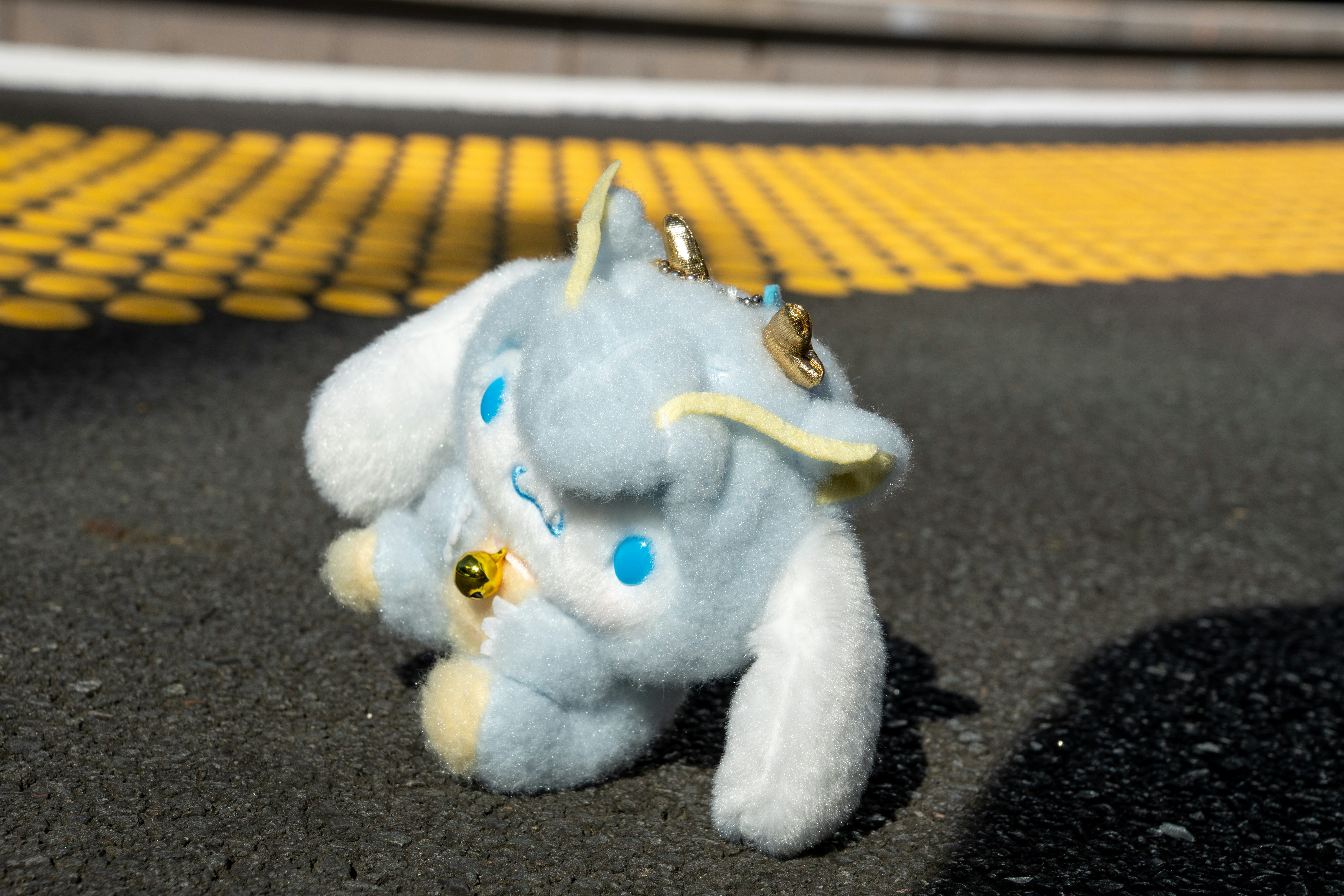 A blue plush toy rests on a platform.