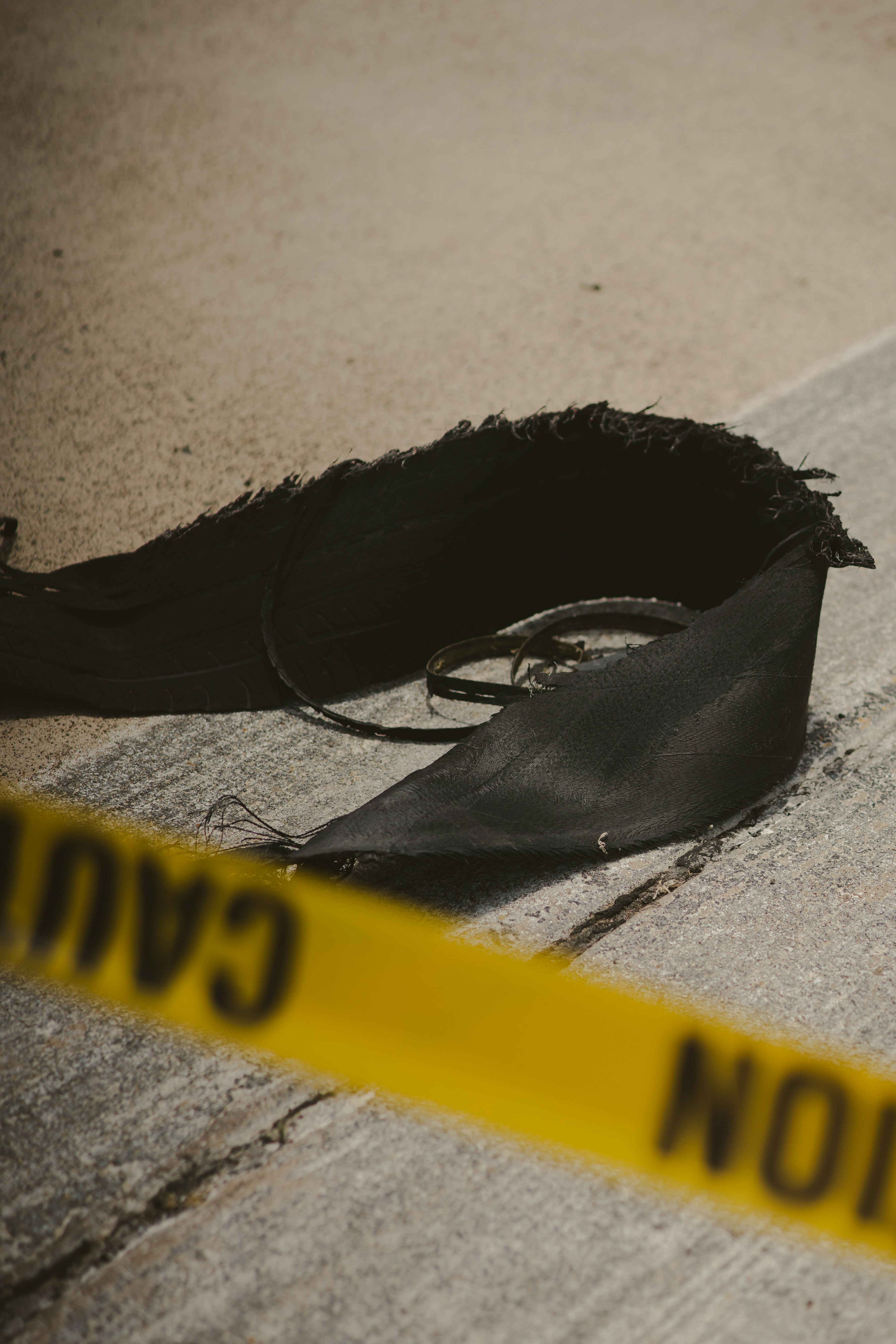 Caution tape surrounds ripped black material