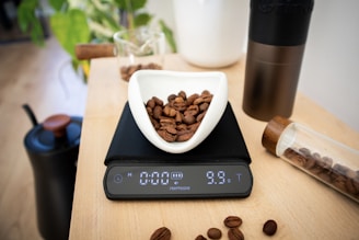Coffee beans are being weighed on a digital scale.