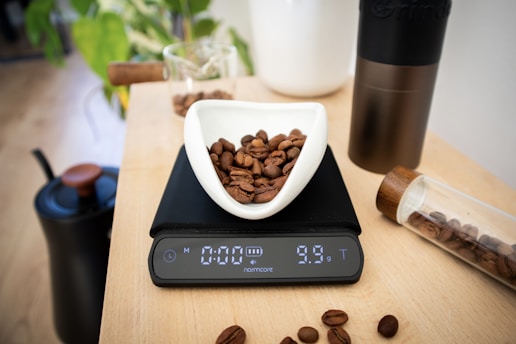 Coffee beans are being weighed on a digital scale.