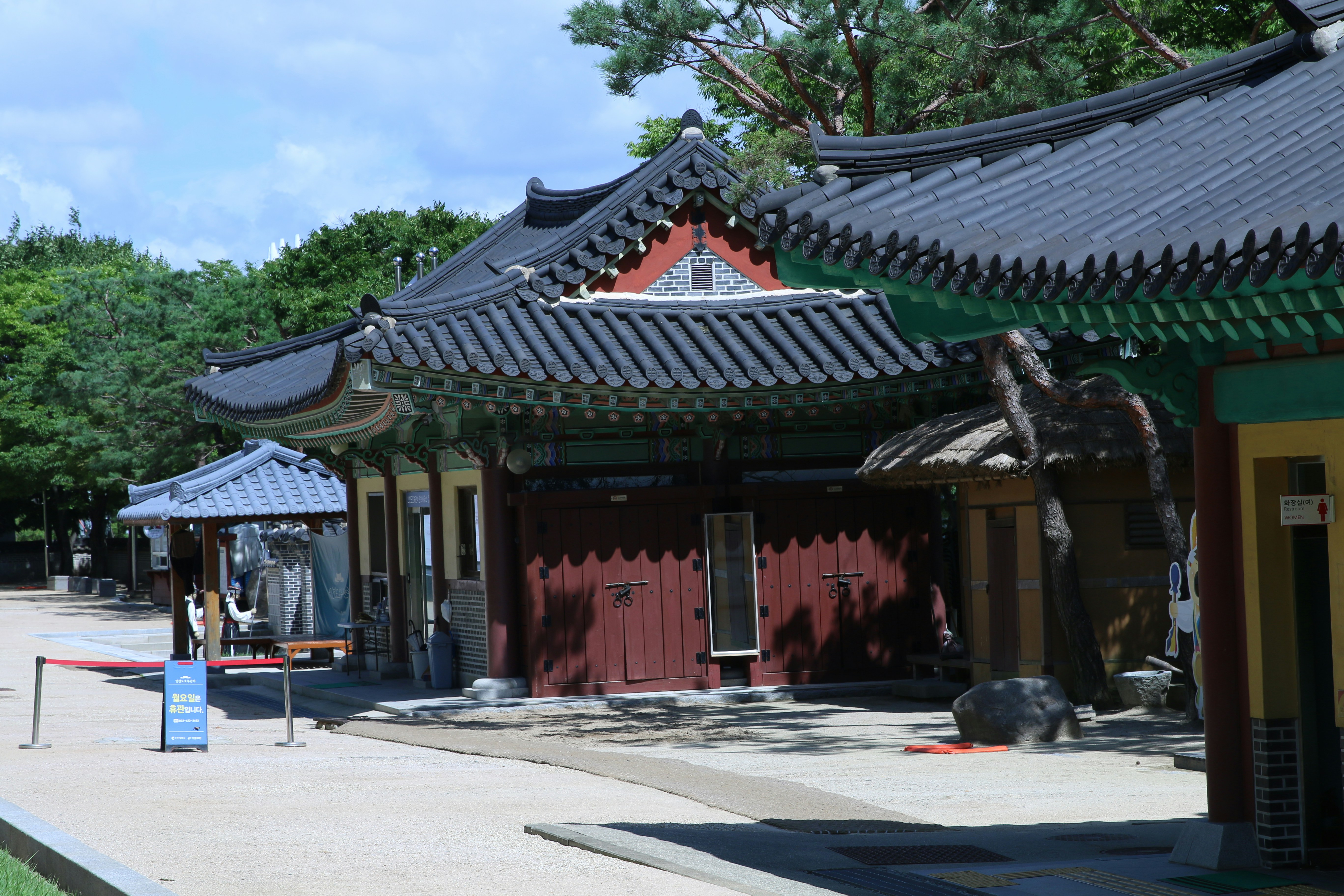 Traditional korean buildings are featured on a sunny day.